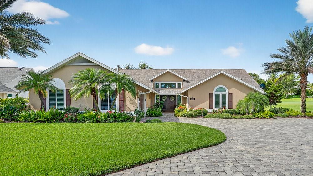 Stunning Waterfront Home in the Sought-After Gated Community of Sugar Mill! This amazing home is situated on one of the most beautiful lots in Sugar Mill! Meticulously renovated waterfront home combines elegant design, luxurious finishes, and an unbeatable location. From the impeccable landscaping and freshly painted exterior to the expansive paver driveway, this property is love at first sight.
Tucked away on a quiet cul-de-sac, the home welcomes you with dramatic double entry doors and a sun-drenched foyer featuring fixed transom windows and a tiered recycled-glass chandelier. Tile flooring flows seamlessly throughout the main living areas, enhancing the open-concept design.
Enjoy panoramic views of the water and the 9th hole of Sugar Mill’s Blue Course from nearly every living space. The cozy family room features a gas fireplace flanked by custom built-ins, with fixed glass windows above that fills the space with natural light.
The recently redesigned kitchen is a true showstopper. Coastal elements like mermaid tail and artisan tile backsplashes, sea glass and crisp white colored cabinetry blend beautifully with high-end finishes such as stainless steel appliances, a natural gas stove, range hood, and Cambria quartz countertops. Soft-close drawers, ample cabinetry, and a generous pantry ensure style meets function. The adjacent dining area is highlighted by a sparkling crystal pendant chandelier, creating the perfect setting for entertaining.
A whimsical powder room with jungle-inspired wallpaper adds a fun surprise just off the kitchen. Flexible living spaces offer options for a den, home office, formal living room, or even a billiard room—tailor them to suit your lifestyle.
The spacious primary suite features serene views, dual walk-in closets with custom organizers, and a spa-inspired en-suite bath. Enjoy a luxurious soaking tub, frameless glass shower, mermaid tile accents, quartz double vanity, bidet, and sleek marble-look porcelain tile throughout. Don’t miss the unique double-sided mirror pocket door!
Two well-appointed guest bedrooms are situated near a beautifully updated bathroom with blue-toned tiles, hexagon tile shower floor, and an indigo vanity and cabinets that tie the design together. The interior laundry room offers storage and counter space to make everyday chores easier.
Step outside to your private red brick patio overlooking the water—a perfect place to relax and take in nature’s show, with frequent visits from birds, ducks, otters, and more. For cooler evenings, gather around the natural gas firepit and unwind. Extended pavers wrap around the back and side of the home for added outdoor living space.
The oversized garage features a separate golf cart entrance, EV charging station, and dedicated golf cart charging area. Additional upgrades include: recessed lighting throughout, custom closets in every bedroom, plantation shutters, three skylights, nearly all new windows (excluding four fixed panes), natural gas tankless water heater and invisible fence for pets
Located on over 100 acres of lush grounds, Sugar Mill is a private, gated community perfect for walking and outdoor enjoyment. Residents have membership options to be a part of the exclusive Sugar Mill Country Club, featuring a 27-hole championship golf course (three 9-hole layouts), tennis and pickleball courts, a full-service clubhouse, restaurant, and fitness center.
This is more than a home — it’s a lifestyle.