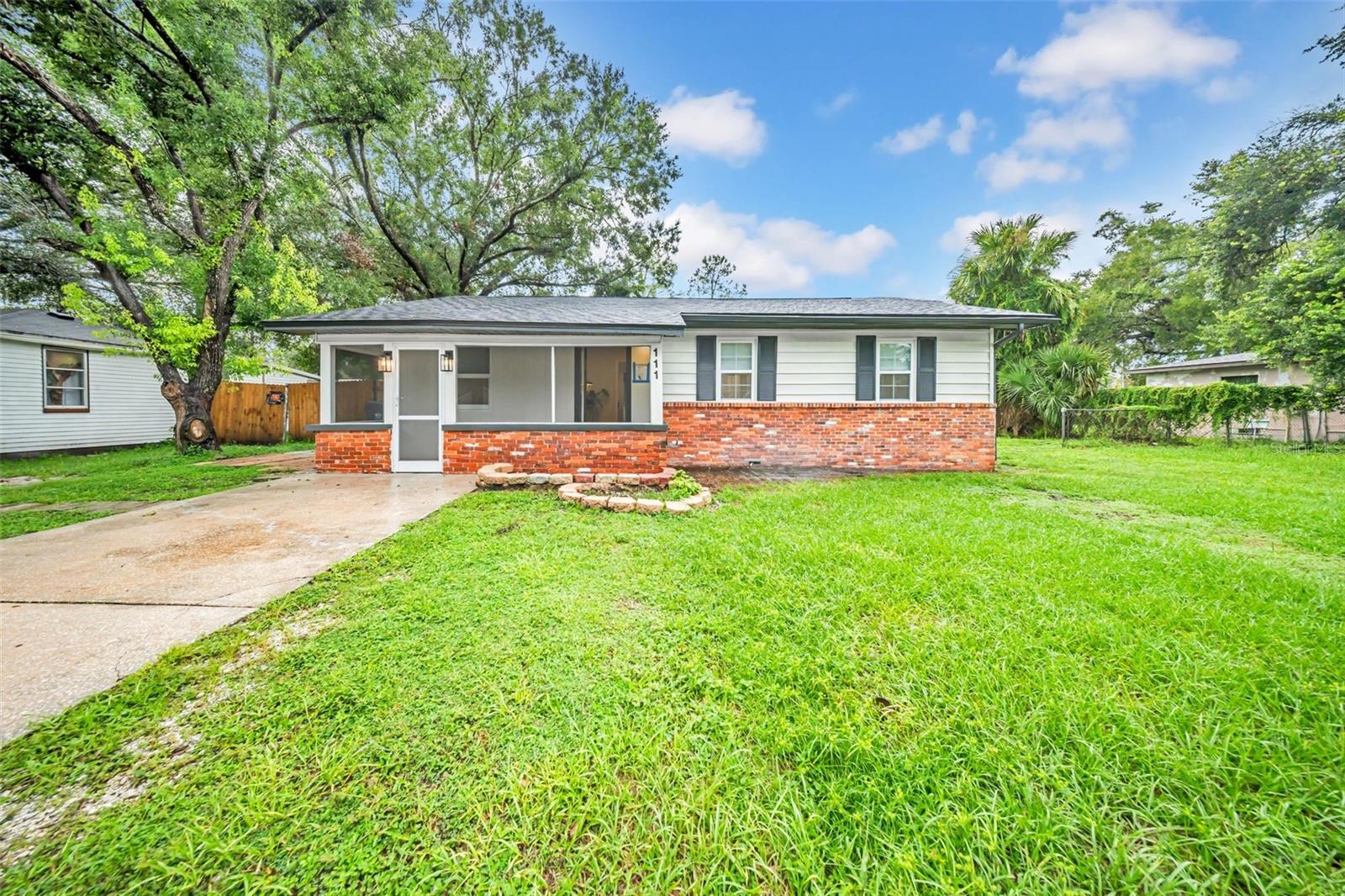 This well-designed 4-bedroom, 2-bath home offers more space and function than you’ll find at this price point. The primary bedroom includes a beautifully renovated en suite with dual vanities. The living room features vaulted wood ceilings, a fireplace, and sliding doors to a rear deck overlooking a large fenced yard with a storage shed. There’s a front screened porch, a generously sized laundry room, and new LVP flooring and paint throughout. Located about eight miles north of Downtown Tampa, Forest Hills offers residents a quiet reprieve from the bustle of city life without having to sacrifice access to amenities. Some of Tampa’s most renowned amenities are just a short drive east of Forest Hills, including Busch Gardens Tampa Bay, Adventure Island, the Museum of Science and Industry, the University of South Florida, and University Mall. ZooTampa at Lowry Park and Raymond James Stadium are both just a few miles south of the community as well. Convenience to Interstate 275 and several major roadways connects Forest Hills to Greater Tampa within minutes. The roof was replaced in 2025. Located in a non-flood zone, this home delivers exceptional value at a great price.