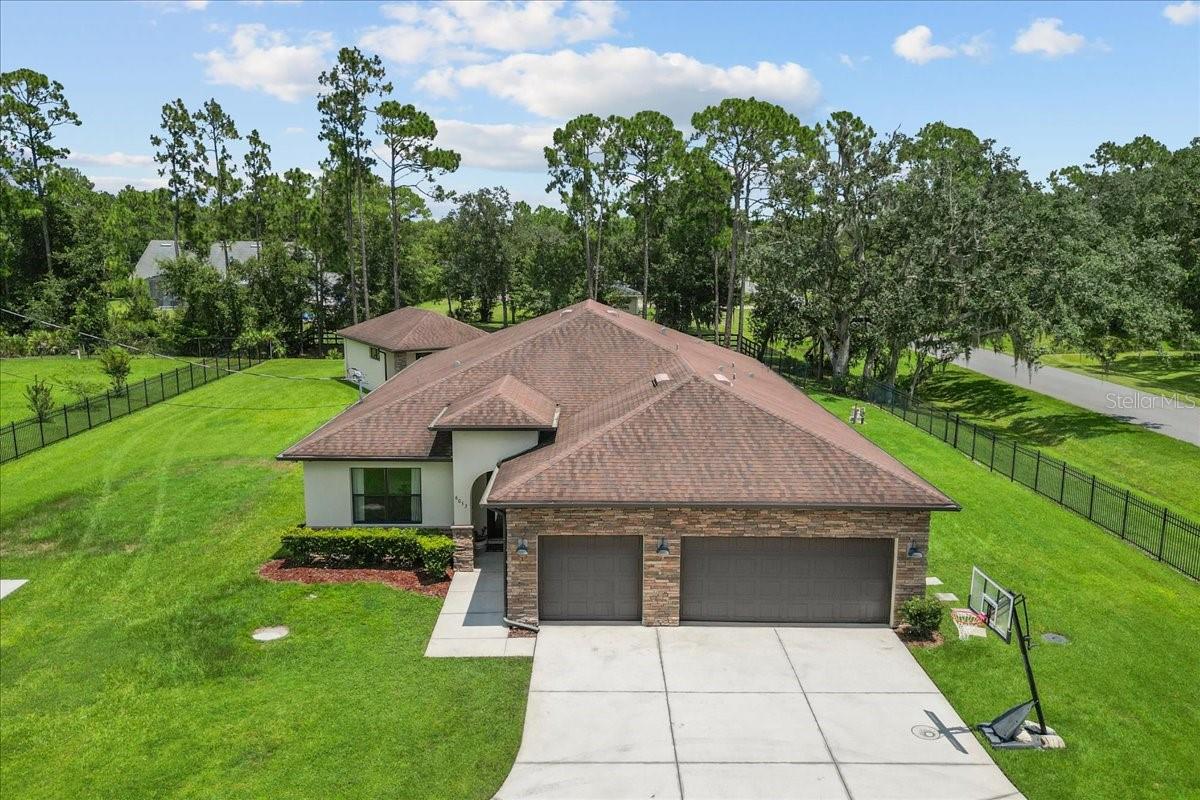 This extraordinary estate offers a seamless blend of elegance, functionality, and resort-style amenities..perfectly designed for entertaining and multi-generational living. Set on a gated, fully fenced acre, this property includes a 4-bedroom, 3-bath main residence plus a 1-bedroom, 1-bath guest house with a kitchenette, living room, and private entrance.
The chef’s kitchen is a culinary dream, featuring a large island with seating, a gas range, three ovens, oversized sink, and a massive butler’s pantry with counters, cabinets, wine fridge, and endless storage. It opens to both the spacious living room and formal dining room, making it the perfect setup for gatherings.
The primary suite is a true retreat, offering direct access to the pool and spa. It features a spa-like ensuite with a double sink vanity, large frameless glass walk-in shower, and a huge 10’x12’ custom closet with built-ins.
Bedroom 2 is versatile and stylish with coffered ceilings, double French doors, a bathroom with walk-in shower and frameless glass doors, and a 10' walk-in closet with built-in organizers, making it ideal as a guest room, home office, or gym. Bedrooms 3 and 4 are set apart from the main living area with a full bathroom between them, offering privacy for family or guests.
Step outside to an entertainer’s dream: a resort-style pool and spa, oversized paver patio, gas firepit, and patio lights that set the perfect mood for evening gatherings. Both the main and guest homes have their own covered lanais, and the extended driveway is perfect for guests, or RV/Boat parking.
Additional features include a 3-car garage, large laundry room with full-size sink, closet organizers in every closet, a central vacuum system, and automatic gated entry for peace of mind.
This is the kind of home that doesn’t just check boxes...it redefines what home should be.
