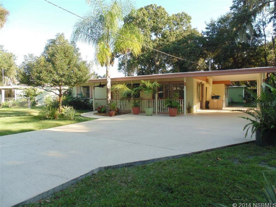 New Roof Installed January 2015!  Fantastic concrete block home on large lot! This home has a very open feel when you walk through the front door. There is a breakfast nook next to the kitchen as well as an additional dining area that can also be a Florida room (2 sets of sliding glass doors give this room lots of natural light).   Kitchen is well laid out with ample countertop space and a breakfast bar!  Over the last 6 years, house has been completely redone with new 18" tile throughout, new interior and exterior paint, new Formica kitchen counter tops, new vanities in bathrooms and more!  Beautiful Southern Pine accent walls in the living room with built in shelves for displaying decorative accents. Large rear porch is screened in for enjoying on cool evenings. There is a 16x14 workshop with electricity and an 8x12 shed in back yard.  Tankless gas water heater is added plus.  Large carport easily holds two cars or boat.  Yard is fully fenced with concrete driveway.  Easy to show! ;Water: City