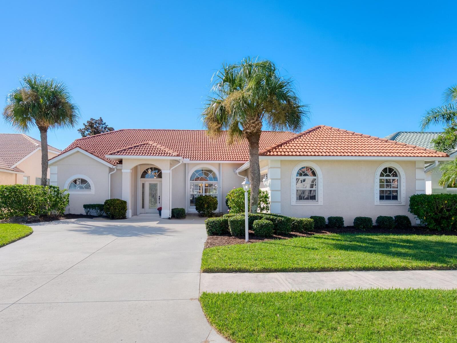 Enjoy sparkling lake views from this spacious 3-bedroom home in the desirable Hidden Lakes Club! This open split-floor plan features vaulted ceilings, skylights, large windows, and pocket sliders that fill the home with natural light. Relax on the expansive lanai or in the heated pool overlooking the lake and fountain. For peace of mind, storm protection includes clear panels, accordion shutters, and a remote-controlled roll-down screen for the lanai. The primary suite offers a luxurious retreat with a sitting alcove and lake views, soaking tub and large shower, private water closet, and dual vanities with a make-up area. Guests will love the two bedrooms and bathroom, which opens directly to the pool area. Additional highlights include abundant closet space, an oversized laundry room with sink, and a large 2-car garage with separate storage room. Hidden Lakes Club residents enjoy a clubhouse with kitchen, library, billiards, and work out area. Outdoor amenities include community pool and spa, and courts for tennis, pickleball, basketball, shuffleboard, and bocce. Conveniently located near shopping, restaurants, I-75, and just minutes to charming and historic downtown Venice and its pristine Gulf beaches.