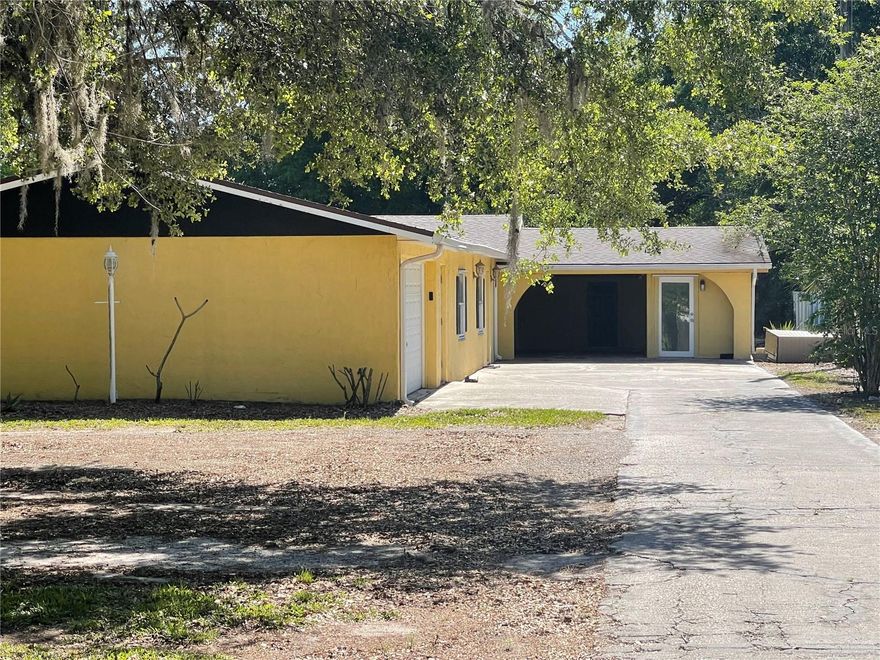 Spacious and versatile, this unique 2-acre property offers the perfect setup for a large or multi-generational family. The main home features 3 bedrooms and 2 bathrooms, a full kitchen, and comfortable living spaces. In addition, a private in-law suite with a separate entrance includes 2 bedrooms, 1 bathroom, and its own full kitchen, living, and dining areas—ideal for extended family or guests.

Enjoy peace of mind with a newer roof, A/C, and appliances already in place. With two full kitchens, this home provides flexibility for a variety of living arrangements.

Outside, the property truly shines with plenty of room to park cars, a trailer, boat, or RV. A 2-car attached garage, 2-car carport, and a large workshop in the back offer ample storage and space for hobbies or projects.

Situated on 2 acres, this property delivers privacy, room to grow, and endless potential—perfect for those looking for space and functionality all in one.