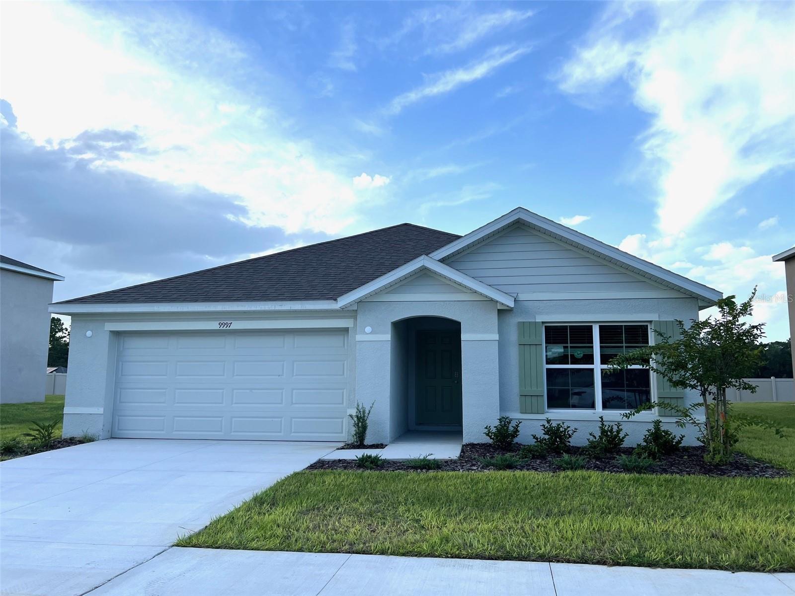 Be the first to occupy this beautiful, brand-new single-family home located in the tranquil and highly desirable community of "Sunset Hills,"
conveniently close to The Villages. This spacious home offers 1,672 sq. ft. of living space, featuring 3 bedrooms and 2 full baths in a one-story, open-concept layout. The modern kitchen overlooks the living and dining areas, making it perfect for entertaining. Additional features include a 2-car garage and a covered lanai perfect for relaxing outdoors. The kitchen comes fully equipped with stainless steel appliances: refrigerator, dishwasher, range, and microwave. A smart home system is also included, along with a full-sized washer and dryer for added convenience. Don't miss out on this exceptional opportunity to make This Beautiful House Your Home!