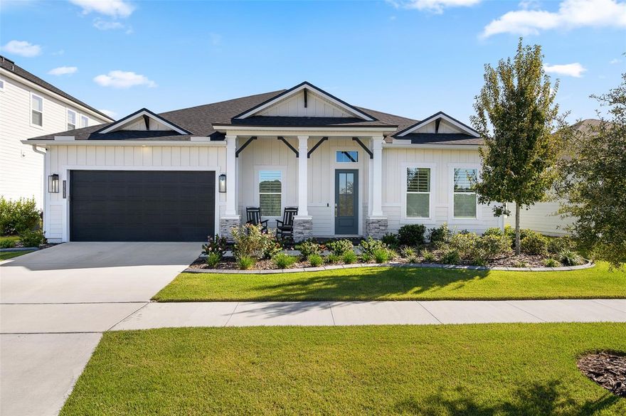 Step into luxury with this exceptional 4-bedroom, 3-bathroom residence in the desirable Oakmont community in Southwest Gainesville. Built in 2024, this home seamlessly blends modern craftsmanship, elegant finishes, and thoughtful design. Entering through the beautiful, custom four-panel rain glass front door you’re greeted by the bright office/study with custom barn doors and a built-in bookcase with a library ladder — the perfect spot for working from home or curling up with a good book. Across the hall, you’ll find two bedrooms and a full bath, with one bedroom featuring charming bookcase closet doors that add a touch of personality. Continuing down the main entry past the gallery with tray ceilings, the kitchen is a true showpiece feature of the home. Double stacked, upgraded deluxe kitchen cabinets, upgraded quartz countertops, upgraded undermount sink, a furniture-wrapped island with decorative X panels, drop-in gas range with hood, wall oven, and custom bricked walls create a space as functional as it is stunning. From here, the kitchen flows seamlessly into the dining room featuring a board and batten wrapped wall that continues into the spacious living room where tray ceilings with gorgeous hand-hewn wood beams and sweeping multi-panel sliding glass doors open to the infinity screened porch, revealing serene views of the fenced backyard that overlooks a gopher tortoise preserve conservation area behind the property. Adjacent to the living room, a third guest bedroom showcases elegant crown molding and is accompanied in the hall by a guest bathroom with upgraded pebble stone in the shower. Across the home, the owner’s suite is a true retreat, offering a tray ceiling, luxurious ensuite bath with upgraded pebble stone shower flooring, dual vanities, and a walk-in closet with built-in closet organizer. Practical elegance continues throughout the home with a mudroom featuring a charming built-in bench and storage, a large double-door pantry connecting to the laundry room, and a three-car tandem garage with ample space for storage or a workshop. Exquisite upgrades extend throughout the home, including plantation shutters, LED recessed lighting, wood-look tile flooring, seamless gutters, a whole-house water filtration system, concrete landscape curbing around the house, and additional insulation in the walls in some areas of the home. Oakmont residents enjoy resort-style amenities, including a clubhouse, fitness center, resort-style swimming pool with lap lanes, tennis courts, basketball court, multi-purpose activity field, and playground, all within a prime SW Gainesville location close to highly-rated schools, shopping, and dining.