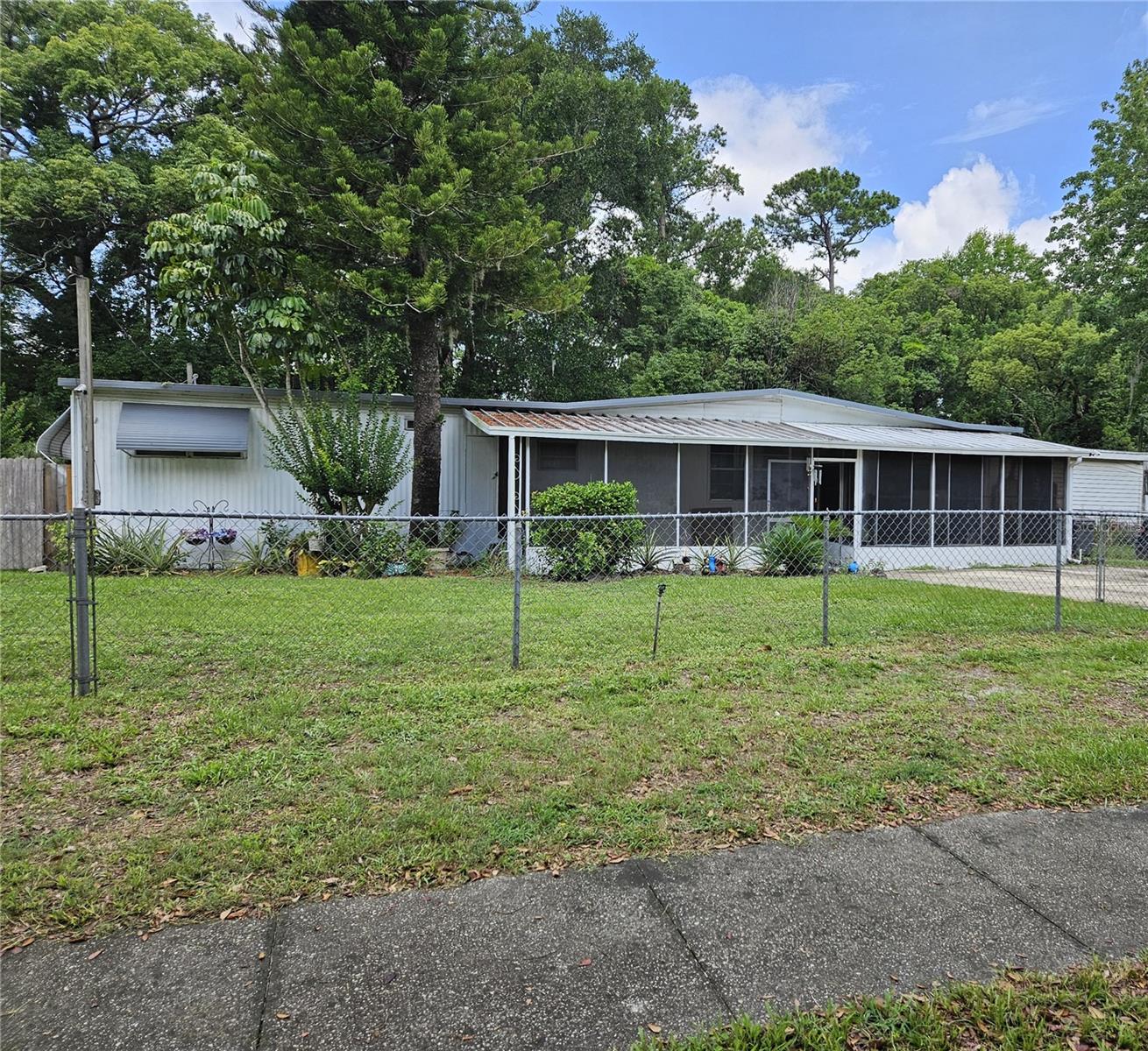 New on the market in the heart of Casselberry, on a quiet dead-end street. Great location, Close to all amenities, good neighborhood with a mix of single-family homes and mobile homes. 2 BR 2 Bath Mobile home with opposite end bedrooms for privacy. MOVE IN READY! on a 75x100 foot lot, which you would own with no HOA OR LOT RENT. The home backs up to a well-maintained pond, which nobody can build behind you. Nicely maintained landscaping with mature trees. all electric with central AC/heat, city water/sewer. Completely fenced in with oversized driveway. Large, screened Sunroom/Porch. Open floor plan. Comes with all appliances including washer/dryer. Has an electric fireplace, sprinkler system, and shed for storage. Also has an additional room on the back with a deck leading out to the large back yard. This is a great starter home or rental for investment. Owner occupied and must call for an appointment. This is an AS IS property. Hurry as this won't last, CALL!