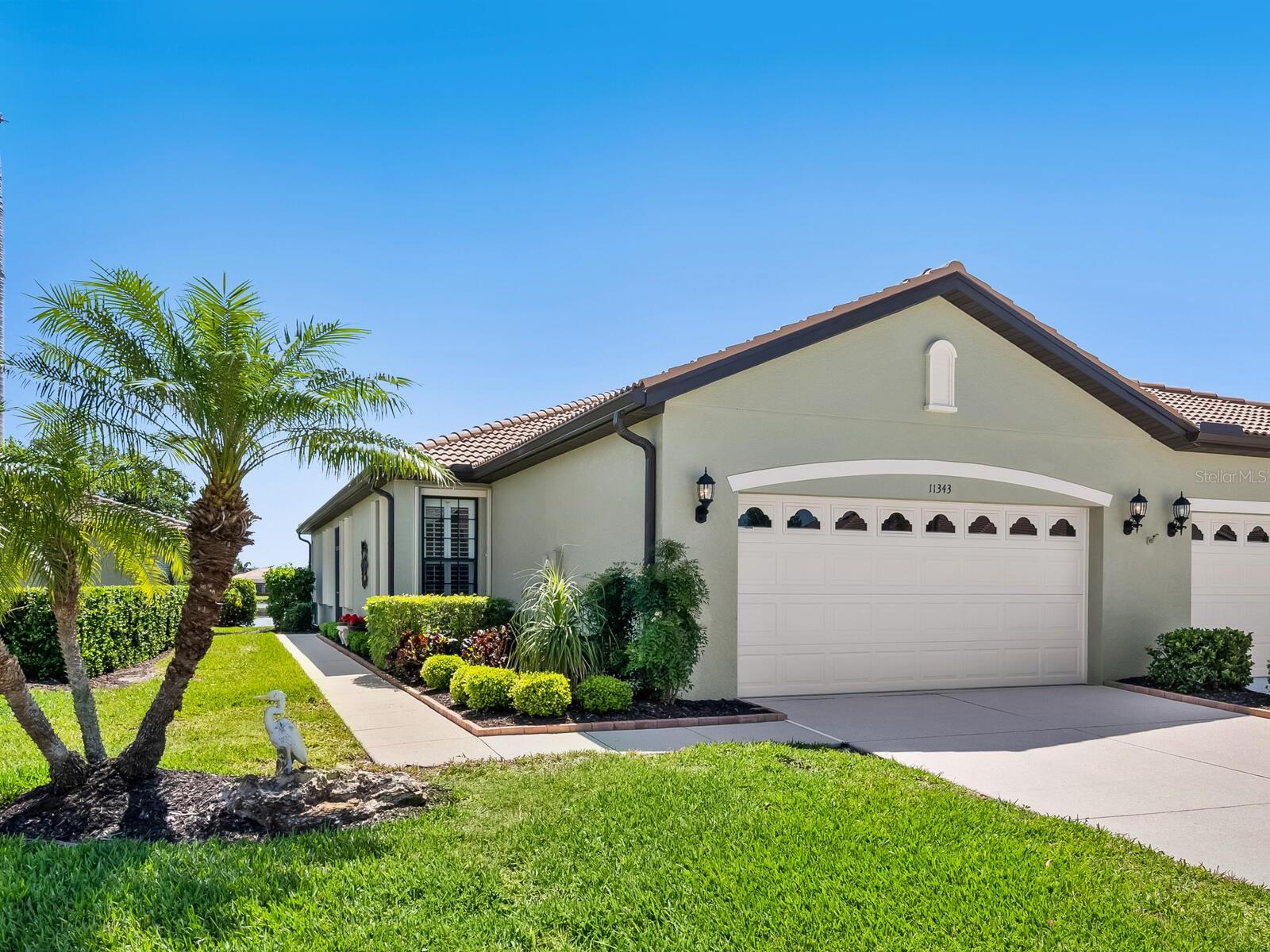 Enjoy shimmering LAKE VIEWS from this beautifully maintained paired-villa featuring two bedrooms plus a den, located in the highly desirable 55+ resort-style community of Venetian Falls. With an UPDATED ROOF, a GENERATOR with transfer box, and ACCORDION STORM SHUTTERS this home offers year-round comfort and peace of mind. Inside, the kitchen features granite countertops, stone sink, a ceiling fan, a skylight that fills the space with natural light, and a charming dining area. The open layout flows into the extended, screened outdoor living space—perfect for relaxing, soaking in the tranquil lake view, and watching birds visit the water’s edge. The Primary Suite offers lake views, a huge walk-in closet, and a spacious bathroom with dual sinks, a Roman shower, skylight, and a private water closet. Thoughtfully designed for privacy, the guest bedroom and bath are located on the opposite side of the home. Elegant plantation shutters, mahogany front door with oval glass insert, and PRO-TILE FINISH on the lanai and front entrance, complete the home. Venetian Falls is known for its exceptional amenities, including a resort-style clubhouse, a heated lap pool and spa, a resistance-walking pool, a fully equipped fitness center, a billiards room, bocce courts, and a full-time activities director, all managed by an on-site team. The reasonable HOA fee covers lawn maintenance, irrigation, roof pressure washing, exterior paint, internet, and basic cable—plus, there’s no CDD fee. Conveniently located just minutes from beautiful Gulf Coast beaches, shopping, dining, and Venice’s vibrant historic district, this home offers the perfect combination of comfort, convenience, and resort-style living. Don’t miss your chance to make it yours!