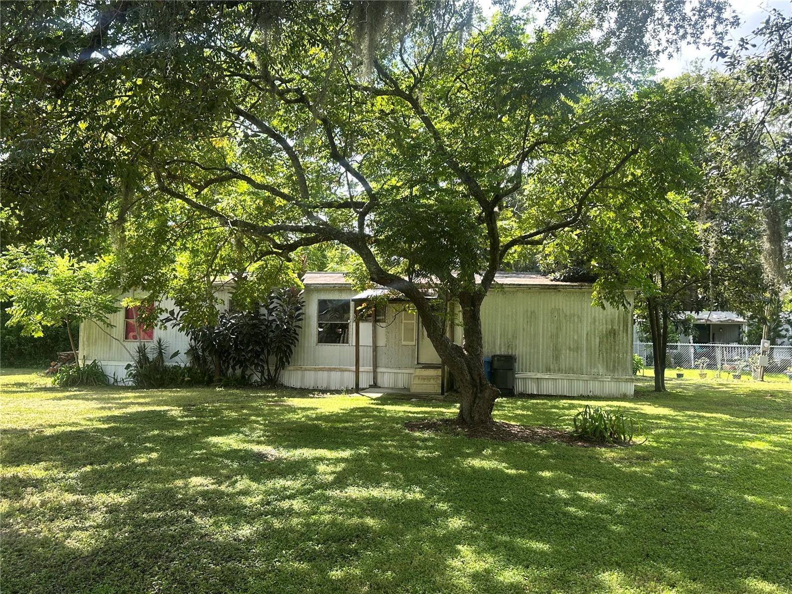Discover potential on this .36-acre (approx. 78 ft by 225 ft) parcel nestled along charming and tranquil Pruett Road in unincorporated Thonotosassa South, Hillsborough County. A 3-bedroom, 2-bathroom double-wide mobile home, offering 1,344SF of heated living space built in 1978, awaits a fresh vision; sold strictly AS-IS, ideal for those seeking a renovation project. The neighborhood is transforming rapidly, with exciting new residential communities like Graceland Estates and Evergreen rising nearby, an Amazon Distribution Center less than 1 mile away, and a growing appetite for mixed-use and industrial developments fueling regional momentum. For additional strategic opportunities, the adjacent mobile home park is also for sale; reach out to the agent for more details. Whether you're looking to revive this home, build your own, or invest in redevelopment, this location offers both privacy and access to the dynamic growth unfolding around it. Buyer to verify utilities, condition, permitted uses; all listing details are drawn from public records. Property has well/septic.