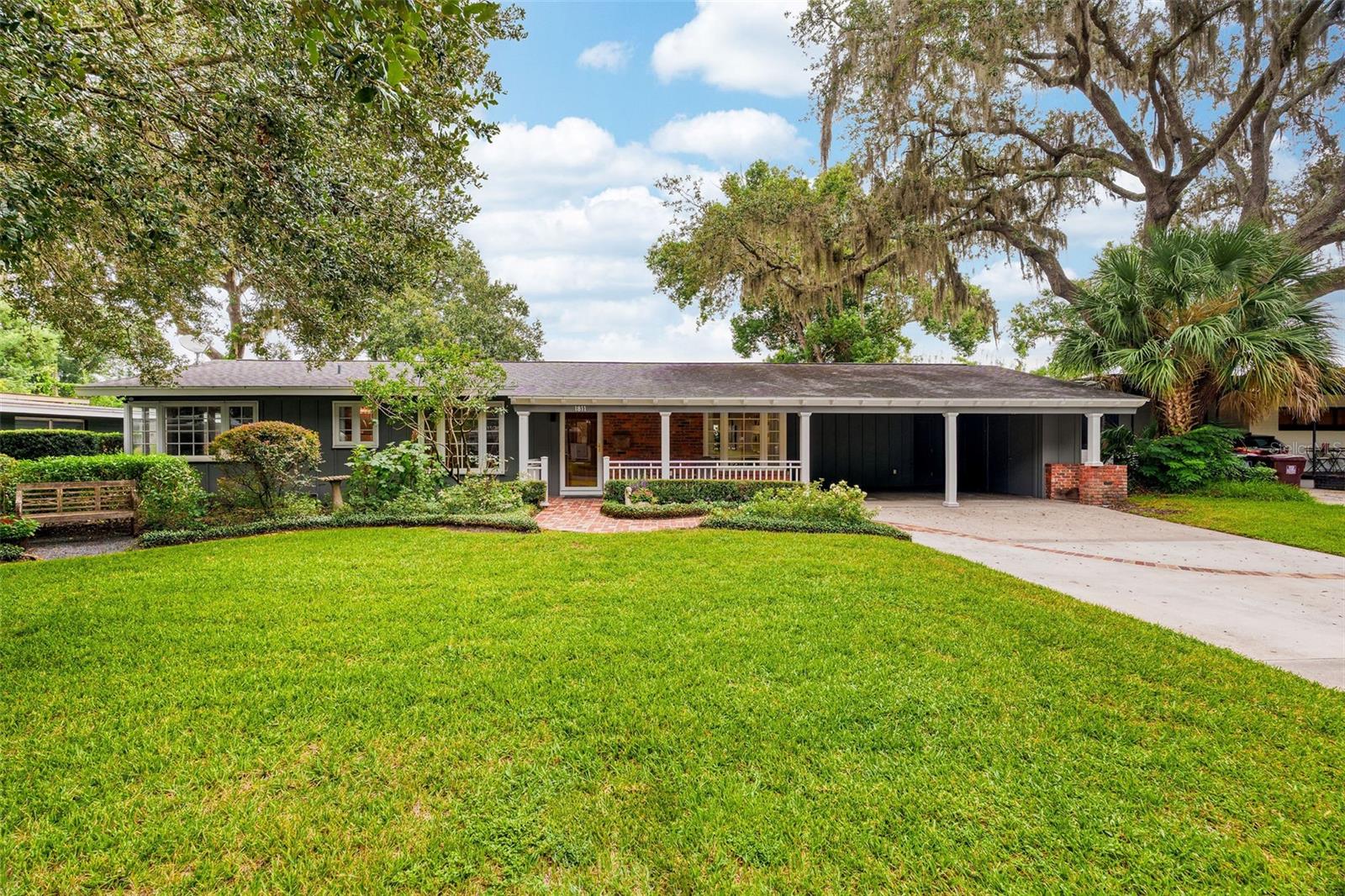 Charming mid-century ranch in Merritt Park, lovingly updated and renovated with 3 bedrooms, 2 baths, a home office, and a bonus room that offers style, comfort, and versatility to its next owner.
Follow the inviting brick front path past delightful flowers and landscaping to the covered porch, where sun filters through the gracious oak tree-lined street of Maplewood Drive. Gleaming original hardwood floors flow throughout this abode and loads of light fill the spacious living room through the unique corner windows. The dining room offers access through French doors to the low maintenance composite rear deck and pergola, a perfect place for al fresco dinners. The huge, grassy, fully fenced backyard is ready for your pets and fun with family and friends.
In the expanded kitchen there is plenty of storage space for all your culinary gadgets with a large pantry closet, solid wood cabinets, and even a granite topped breakfast bar island.
Off the living room is a newly remodeled (2023) and reconfigured area including a hallway with multiple storage closets leading to the laundry room and access to the oversized 2 car carport. You’ll also find a carpeted bonus room with vaulted ceiling, making for the perfect den or playroom, and through the elegant wood and glass double doors, you’ll find a small home office space.
On the other side of the home are 2 guest bedrooms and full hall bath along with the primary bedroom with 2 closets and an updated en-suite.
The many updates include: NEW roof 2020, NEW electrical panel box 2021, NEW fence 2022, NEW sprinkler system 2022, NEWLY renovated/reconfigured bonus room, laundry room, home office, and AC 2023.
Zoned for sought after Audubon K-8 and Winter Park High School, and located within walking distance to Leu Gardens, East End Market, Kelly’s Homemade Ice Cream, and all the shoppes and restaurants of Audubon Park Garden District. Plus, a short commute to downtown Orlando and downtown Winter Park means this location can’t be beat.