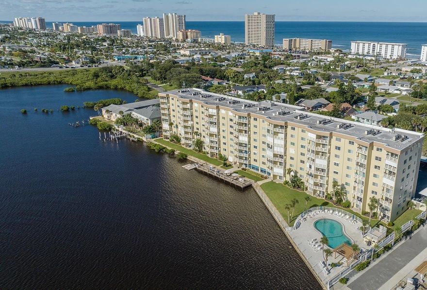 Welcome to riverfront living at its finest! This exquisitely renovated, fully furnished 1-bed, 1-bath condo offers turnkey coastal living. Open the front door and your gaze will be drawn past the glass sliding doors to the panoramic, shimmering water views of the Intracoastal Waterway—all from your private balcony. Your senses will delight in the exceptionally clean, light, and homey interior. The white, gray, and beige décor enhances the serenity of your new coastal retreat, while quartz countertops, shiplap accents, and wainscoting add understated beachy elegance. The renovated, open kitchen is a dream, with plenty of counter space and a breakfast bar that flows into the dining area and beautifully appointed family room.  When cooking, eating or reading, you’ll enjoy captivating views from your private balcony as boats glide by, dolphins and manatees play, and a myriad of water birds sail the currents at eye level—not to mention spectacular sunsets each night. Your spacious primary bedroom offers its own river and sunset views and includes a fully renovated en-suite bathroom. The condo’s expansive Pelican Lounge offers billiards, ping-pong, a library, large-screen TV, and even a community puzzle always in progress. The chef’s kitchen is available for residents' use—or simply stop by for sunset with your favorite drink and mingle with neighbors. Outdoors, you can launch a kayak from the floating dock, fish your cares away on the private boardwalk, grill at the BBQ area, or relax by the heated pool and lounge under the covered gazebo. Located on a quiet, no-thru street, you’re just three blocks from the surf and sand of “The World’s Most Famous Beach,” and close to chic and casual eateries, trendy coffee shops, marinas, the historic Ponce Inlet Lighthouse, shopping, the Daytona International Speedway, and the iconic Bandshell with free summer concerts. The possibilities are as endless as the sunrises over the ocean and sunsets on the river. Whether you're looking for a peaceful retirement retreat, a smart Florida investment, a seasonal escape, or a full-time waterfront home, this beachside dream condo on the river has it all. Fully furnished and move-in ready—just bring your toothbrush. Opportunities like this don’t last long—schedule your private showing today before it’s gone!