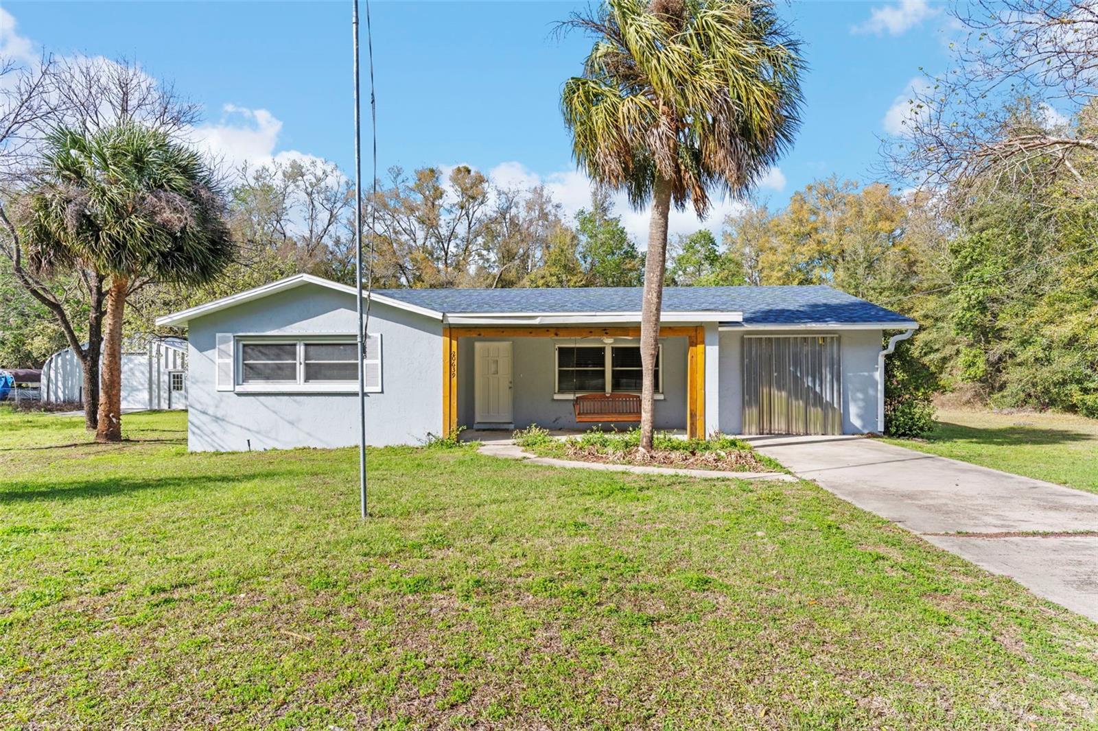 Lease-to-own option available. Eligible for full financing!!! NO HOA. Live/work options. Can be income-producing. A unique property fully renovated; new roof, 2 storage utilities, and a huge 41 x 30 Hangar/Quonset hut with electricity and hurricane storm panels that can be used for storage, parking, a workshop, or converted into a separate suite. Home has 3 bedrooms, 2 baths, a Florida room/sunroom, and is wired for a full home generator. All appliances convey. Land is a rare commodity in the central Florida area, and this property has plenty of it with almost a half-acre. Property is unincorporated. Plenty of opportunity with this beautiful property.