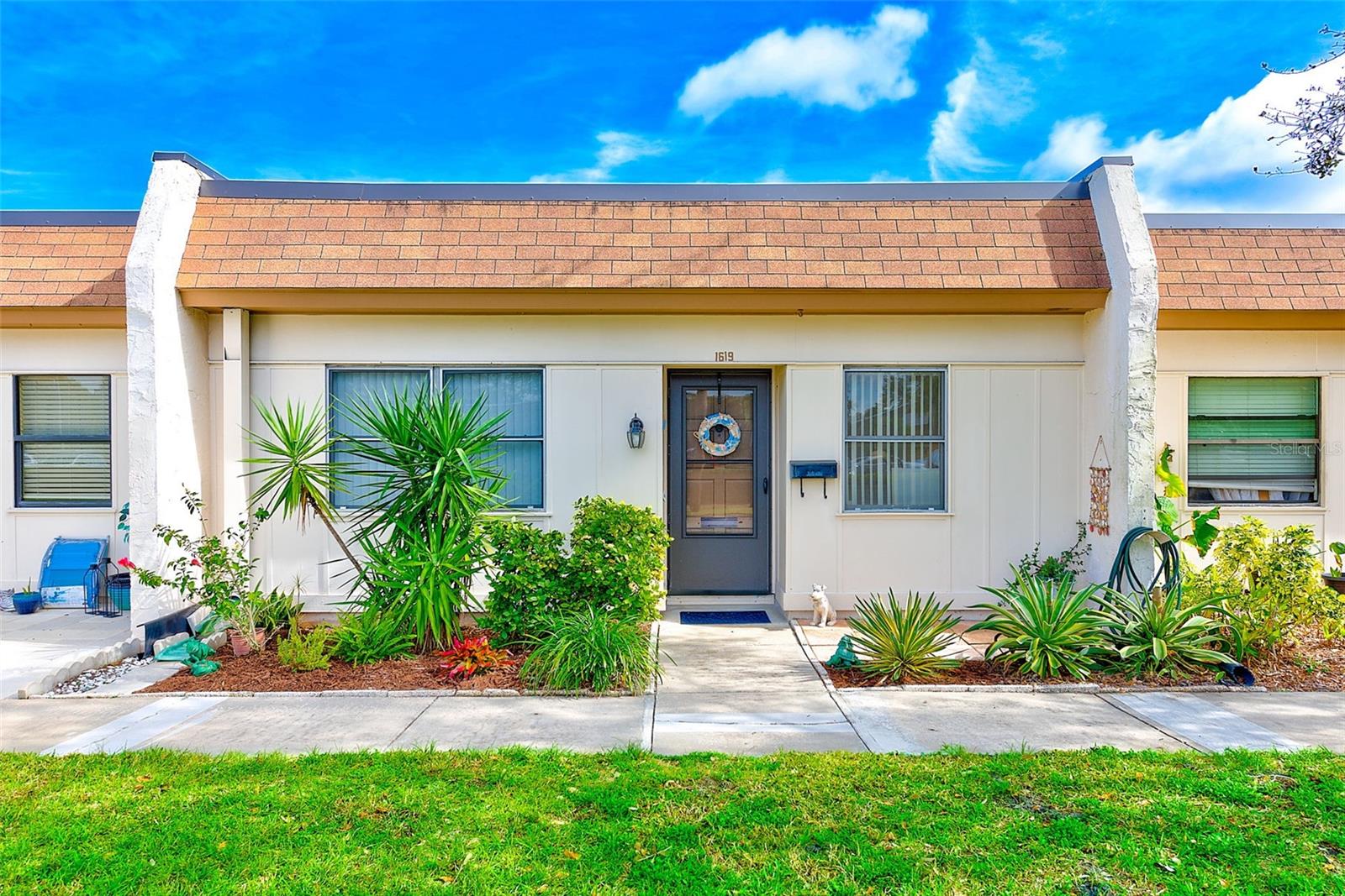 Welcome home to this FURNISHED 2 Bed/2 Bath villa with an end carport spot and storage in desirable 55+ Mission Hills community. This unit offers an open kitchen with breakfast bar, full size dishwasher, newer AC (3 years old), large living room with pull out trundle couch, spacious dining space, wood laminate & tile floors, primary suite with walk-in Bath Fitter shower, updated guest bathroom with tiled walk-in shower, washer & dryer inside the unit, and new mattresses in both bedrooms. Enjoy the nicely paved back patio overlooking the beautiful courtyard where you can grill and relax! Included in the monthly fee is cable, internet, natural gas, water, sewer, trash, roof, exterior & grounds maintenance, clubhouse, community pool and the land lease. The active Mission Hills community clubhouse offers a social room for gatherings, a library, fitness area, pool table, ping pong, shuffleboard, and large heated community pool. Excellent Clearwater location convenient to restaurants, shopping, grocery, hospital, airports, entertainment, beaches, downtown Safety Harbor and Dunedin! Available for lease between 3 to 6 months.