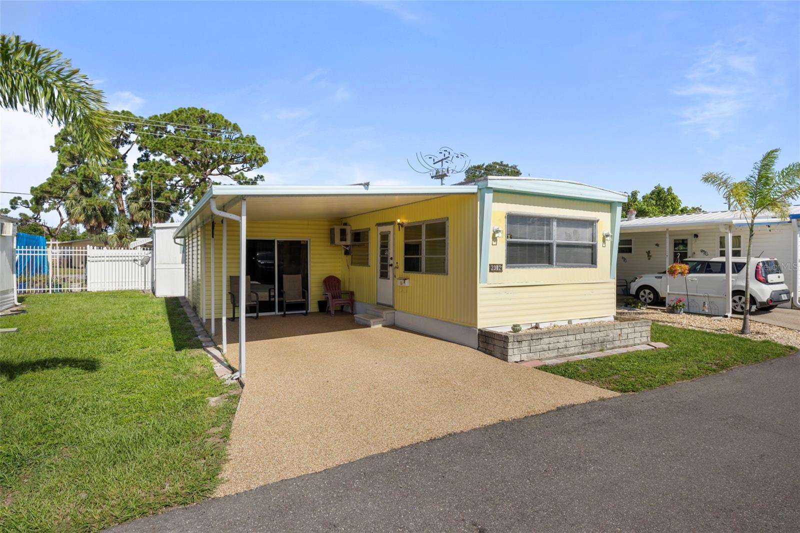 Welcome to your Florida retreat nestled within the friendly and active 55+ community of Bradenton Tropical Palms. This charming single-wide TURN-KEY manufactured home offers comfortable living with a low-maintenance lifestyle. Featuring an open floor plan, updated kitchen, and den that doubles as a second bedroom with ample storage for a closet or second bathroom addition, this home is perfect for seasonal weekends or year-round retirement living. Furnishings include: all appliances, three window A/C units, sofa, loveseat, chairs, television, two full-sized beds, and all basic bedding and kitchen necessities. Just unpack and hit the beach! Or enjoy the Florida sunshine on your private covered porch or stroll through the beautifully landscaped community grounds. Community amenities include clubhouse and social activities, swimming pool and hot tub, shuffleboard and recreational facilities, along with gated security. Close to beaches, shopping, and golf courses along with low HOA! Don’t miss out on this fantastic opportunity to live in a vibrant community near the Gulf Coast!