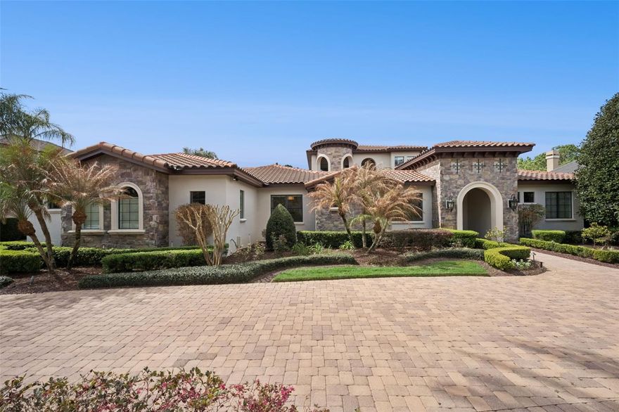 Spectacular lakefront sunsets and complete privacy define this timeless tuscan-inspired retreat just minutes from the charm of historic Mount Dora. Located in an exclusive gated community with convenient access to Orlando, this exceptional residence offers the perfect balance of peaceful waterfront living and proximity to dining, boutiques, and cultural events. Designed for effortless indoor-outdoor living, expansive covered terraces overlook the water and create multiple spaces for gathering and relaxation. The resort-style pool and spa anchor
the outdoor living experience, complemented by 2 outdoor fireplaces, a gas firepit, and an outdoor kitchen- an extraordinary setting for sunset evenings and lakeside entertaining. Inside, the home unfolds into a stunning great room with sweeping lake views, creating a
dramatic yet inviting centerpiece for the residence. Refined finishes and timeless architectural details enhance the warm, elegant atmosphere throughout the home. The thoughtfully designed split floorpan offers both comfort and privacy, featuring 4 bedrooms and 4 en-suite baths, ideal for hosting family and guests. The oversized climate controlled 4 car garage is perfect for the car enthusiast. A large chef’s kitchen features Sub-Zero and Wolf appliances make preparing meals for large or intimate gatherings a pleasure. Whole house surround, Water softener, Water filtration system, Water leak detection system, Salt water pool, Solar panels for pool, outdoor cameras etc are just some of the homes features. A rare opportunity to own a private waterfront sanctuary where breathtaking sunsets, exceptional entertaining spaces and the relaxed sophistication of lakefront living all come together.