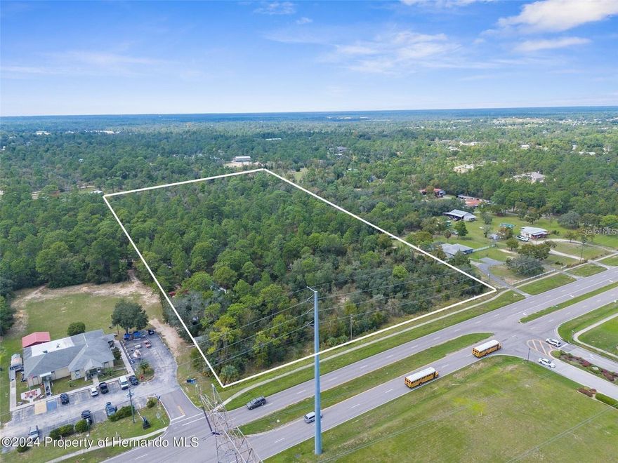 4.9 ACRES directly across from the entrance of SPRING RIDGE SUBDIVISION!! AADT (Annual Average Daily Traffic) 14,500!! Public water and sewer nearby!! This is the parcel directly north and adjoining the Marine Corps League building/property! GREAT GROWING LOCATION!! Potential commercial and/or multi-family residential for duplexes, triplexes, or quadplexes. Potential for commercial in the front and residential/multifamily in the rear. Sunshine Grove Road is a growing area very close to the schools: Pine Grove Elementary, West Hernando Middle School, and Central High School. The BUSY central hub of Hernando County (Mariner and Cortez) is just minutes away with all sorts of shopping, grocery stores, movies, restaurants and so much more!! 5 minutes to the Suncoast Parkway (589) for quick and easy access to Tampa Bay!! Everything you need is minutes away!! So much potential for this property!! Call today for more details.