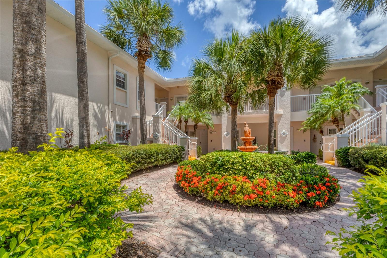 Step into a world of tranquil luxury at Plaza de Flores, an exclusive gated community that creates a serene lifestyle. Nestled in a coveted corner of this picturesque neighborhood, discover a 2-bedroom, 2-bathroom sanctuary offering an open layout that exudes Florida elegance and comfort. Upon entering the condo, you are greeted immediately by the view of a stunning screened-in lanai and tranquil pond - the perfect spot to savor your morning coffee in the mornings or a glass of wine in the evenings. The seamless flow from the kitchen to the charming dining nook with dry bar and into the inviting living room creates an atmosphere that beckons you to unwind and entertain in style. Designed for utmost privacy, the bedrooms are strategically positioned on opposite ends of the condo. Your lavish primary suite beckons with sliding glass doors to the lanai, natural light, dual walk-in closets and an en-suite primary bathroom featuring dual sinks, and a separate water closet with standing shower. The versatile second bedroom has a space-efficient layout with a sleeper-sofa, desk, hutch, and closet. The second bathroom offers the convenience of both a shower and a bathtub. Additionally, the there is an in-unit washer-dryer laundry closet. Outside, immerse yourself in the meticulously maintained grounds adorned with mature landscaping, tranquil ponds, and soothing fountains. Enjoy resort-style amenities including a geothermal heated pool, in-ground spa, gazebo over a lake, tennis court, and a charming clubhouse equipped with a fitness center, card room, library, kitchen, and flexible gathering space. Perfectly situated in proximity to shopping destinations, one mile from The Legacy Trail, and under 5 miles to famed Siesta Key, Plaza de Flores offers an enviable location, creating a lifestyle of both comfort and convenience. Don't delay, this remarkable haven is awaiting you. To see updates to furniture or linens, video available upon request.