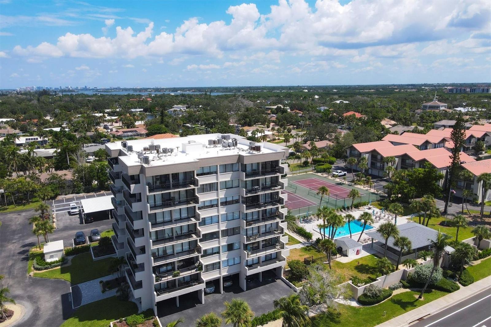 ANNUAL FURNISHED CONDO RIGHT ACROSS THE STREET FROM SIESTA KEY BEACH! Experience the perfect blend of nature and culture with this stunning, fully renovated two-bedroom, two-bath corner unit condo, available for annual lease! This light-filled, spacious 4th-floor residence features two walls of glass sliders opening to two large, furnished balconies, offering seamless indoor/outdoor luxury living. Just steps from world-renowned Siesta Beach, consistently rated among the best beaches globally, this condo is situated in a meticulously maintained building with resort-style amenities, including tennis courts, a heated swimming pool, and a large covered picnic pavilion with a grill. Enjoy expansive windows in every room, in-unit laundry, air conditioning, three new flat-screen smart TVs, linens, and all essentials for a comfortable, stylish home. The beautifully landscaped gardens enhance the serene atmosphere. Conveniently located, you're a short drive from downtown Sarasota, where you’ll find fine dining, shopping, museums, theaters, and art galleries. There is even a complimentary trolley to take you to Siesta Village shopping and restaurants. Embrace comfort, style, and the ultimate coastal lifestyle in this exceptional rental! One covered parking spot included as well as additional guest parking. Water, basic cable, and internet are included.