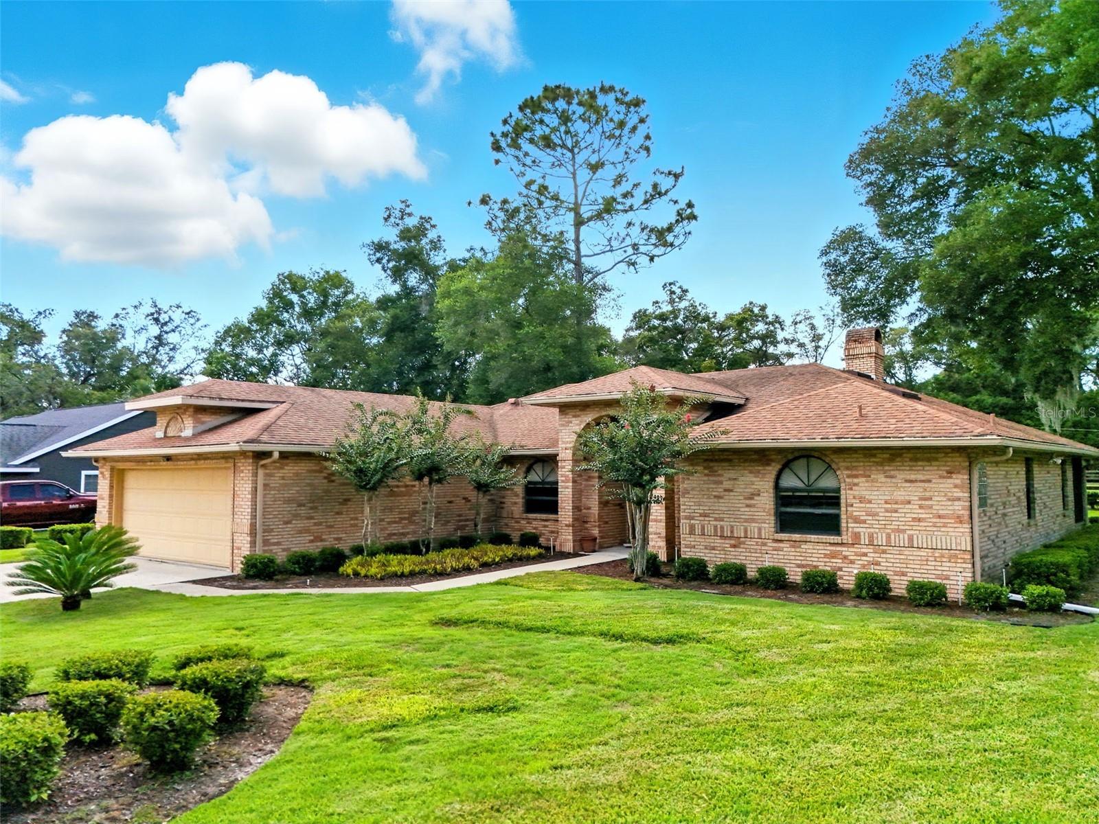 Welcome to this beautifully maintained 3-bedroom, 2-bath home in the sought-after community of MOUNT PLYMOUTH. From the moment you step inside, you’ll notice the thoughtful layout and inviting atmosphere. The primary suite is located just off the entry to your right, offering a peaceful retreat with a large walk-in closet and a private bath. To your left, the formal dining room is ready for memorable gatherings, while the cozy living room features a wood-burning fireplace. At the heart of the home, the kitchen shines with a Jenn-Air stove, stainless steel refrigerator, a sleek composite graphite sink, pantry storage, and a space ready for your dishwasher. The cheerful breakfast nook overlooks the backyard, and multi-slide patio doors lead to a screened porch ideal for enjoying your morning coffee or a quiet evening breeze. The porch is already plumbed for your future hot tub! The split floor plan ensures privacy, with two additional generously sized bedrooms and a full bath on the opposite side of the home. Storage is abundant, with a linen closet, laundry room with cabinetry, attic storage above the two-car garage, and plenty of room for your boat or toys. The washer and dryer are included for your convenience. Outside, the meticulously kept yard adds to the home’s appeal. Septic Drain Field replaced 2025. Located in a golf cart-friendly neighborhood with NO HOA, you’ll have easy access to SR-429, the Neighborhood Lakes Scenic Trail & Trailhead, East Lake Sports & Community Complex, and Lake Lucie Conservation Area. This home offers the perfect blend of comfort, style, and functionality—ready for you to move in and make it your own.