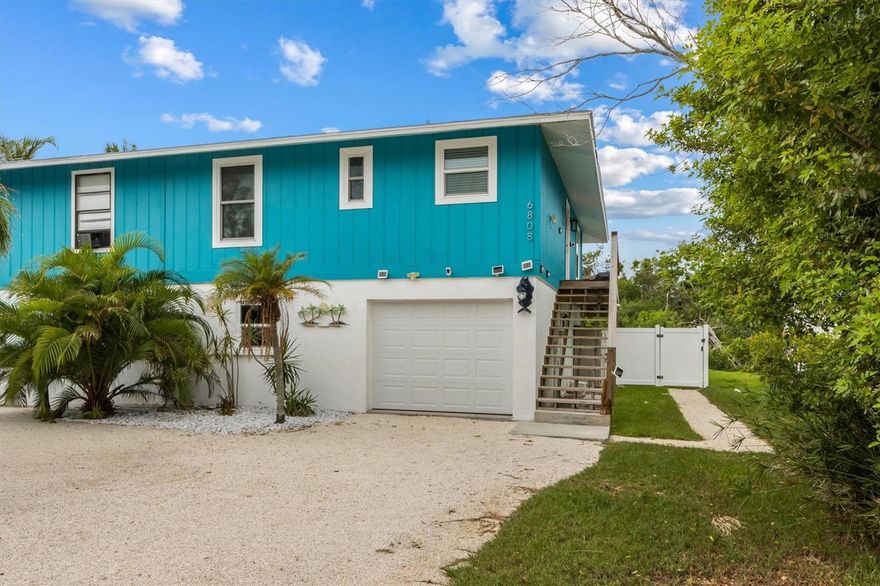 Welcome to Palm View Lakehouse in Holmes Beach. This fully renovated 2-bedroom, 2-bath ELEVATED half duplex was updated in 2022 and allows for weekly rentals, offering excellent investment potential with nearly $50,000 in year-to-date bookings and almost to $60,000 in bookings in 2024, plus several bookings already secured for next year. The home features luxury vinyl plank flooring throughout, granite countertops, stainless steel appliances, and IMPACT windows and doors, with both bathrooms updated with new tile and vanities. Outside, enjoy a PRIVATE heated saltwater pool, along with a DOCK added in 2023 where you can fish, kayak or paddleboard. Other recent improvements include a AC in 2021 and new garage door in 2025. Close in proximity to the Gulf beaches, dining, and shopping, this property blends island living with convenience and comfort.