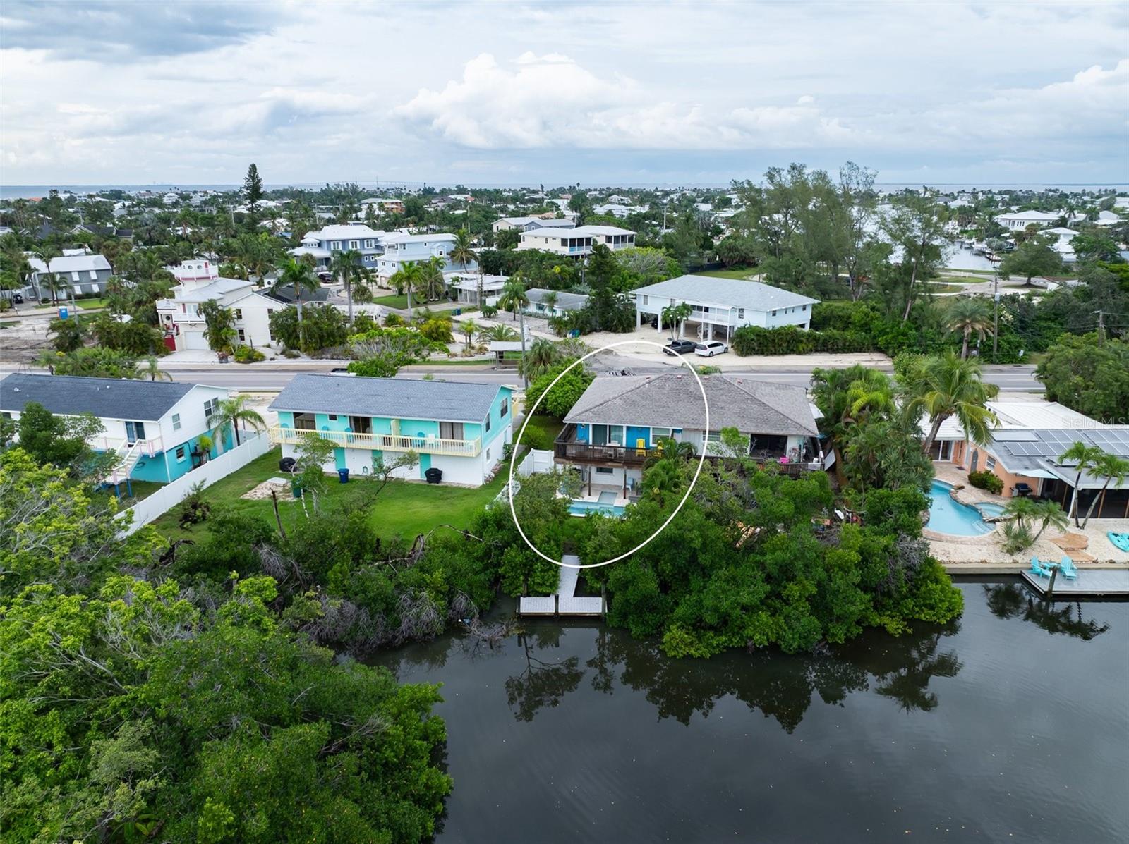 Welcome to Palm View Lakehouse in Holmes Beach. This fully renovated 2-bedroom, 2-bath ELEVATED half duplex was updated in 2022 and allows for weekly rentals, offering excellent investment potential with nearly $50,000 in year-to-date bookings and almost to $60,000 in bookings in 2024, plus several bookings already secured for next year. The home features luxury vinyl plank flooring throughout, granite countertops, stainless steel appliances, and IMPACT windows and doors, with both bathrooms updated with new tile and vanities. Outside, enjoy a PRIVATE heated saltwater pool, along with a DOCK added in 2023 where you can fish, kayak or paddleboard. Other recent improvements include a AC in 2021 and new garage door in 2025. Close in proximity to the Gulf beaches, dining, and shopping, this property blends island living with convenience and comfort.