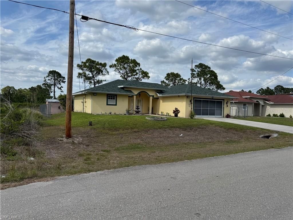 Photo of 1127 Foggia Street E, Lehigh Acres, FL 33974 (MLS # A4649505)