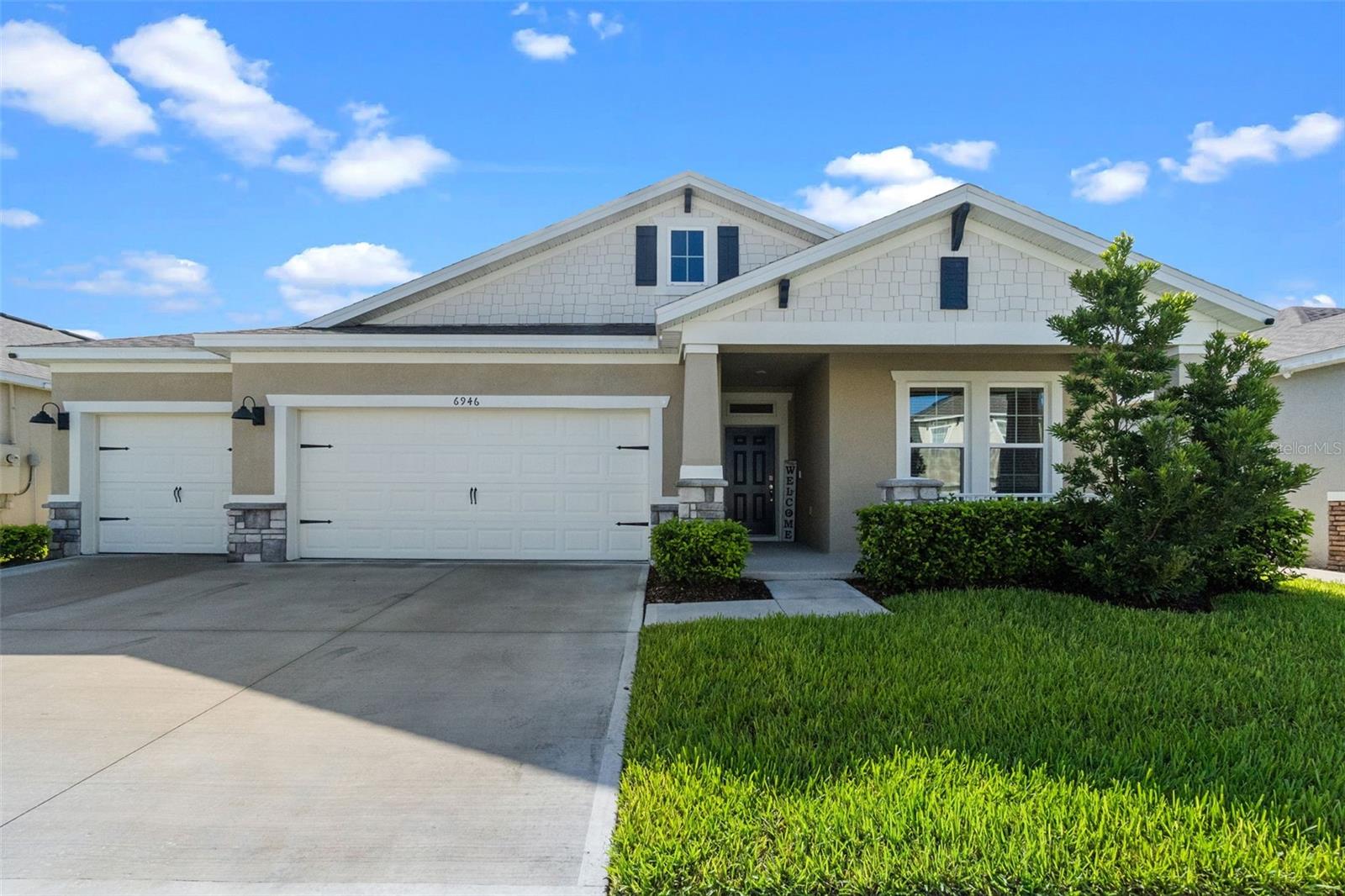 Welcome to 6946 Audubon Osprey Cove – Located in The Villages at Harmony. Discover the perfect blend of comfort, style, and serenity in this meticulously well maintained 4-bedroom, 3 full bathroom home, situated on a premium waterfront lot with no rear neighbors and captivating views of the pond and surrounding conservation area. Enjoy tranquil evenings on your back patio while taking in the sights and sounds of nature, with no rear neighbors and unobstructed views of the water and conservation area. From the moment you step inside, you'll be welcomed by a spacious foyer that opens into an airy open-concept floor plan featuring a large kitchen, spacious dining room, and roomy living room with oversized windows that flood the space with natural light and showcase the peaceful outdoor scenery. The heart of the home is the modern kitchen, complete with granite countertops, a large island with seating for four, and sleek tile flooring that flows seamlessly through all the main living areas. Plush carpet adds warmth and comfort in each of the bedrooms. Retreat to the luxurious primary suite, where you’ll find a spa-like en-suite bathroom featuring a garden tub, separate glass-enclosed shower, and dual vanities with granite countertops. A 3-car garage provides plenty of storage and flexibility for vehicles. Located in the highly desirable Villages at Harmony, this home offers the perfect combination of privacy, elegance, and community living.