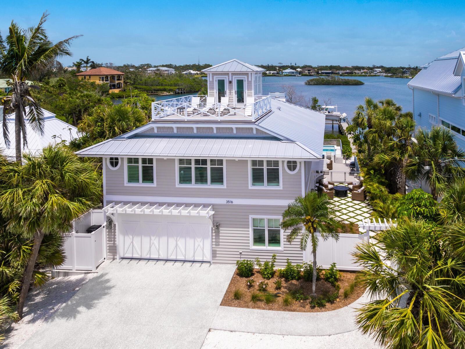 Casey Key Gulf-to-Bay | Private Beach | Curated Waterfront Residence.
Welcome to this rare Gulf-to-Bay property on exclusive Casey Key, where timeless design meets modern coastal luxury. Reimagined and renovation completed in 2023— a new resort-style pool and spa added in 2025—this move-in-ready oasis offers private beach access, sweeping Intracoastal Waterway views, and a relaxed yet refined lifestyle.
Expansive open living spaces are filled with natural light and feature wide-plank wood flooring, exposed wood beams, and clean architectural lines. A working fireplace anchors the living room, connecting seamlessly to the great room and a chef-inspired kitchen.
The dual-concept kitchen is equipped with two Sub-Zero refrigerators, a Wolf range, two Asko dishwashers, and dramatic Zeus quartzite countertops. Custom cabinetry, designer lighting, and a spacious layout make it ideal for both everyday living and entertaining.
With four bedrooms, three and a half bathrooms, and a dedicated study/den, the floor plan offers flexibility and privacy. Upstairs guest suites enjoy spectacular water views from every room. An upper-level deck overlooking the Gulf is perfect for sunset viewing and quiet evening relaxation.
Built for coastal durability, the residence features hurricane-impact doors and windows, a standing seam metal roof, and cedar siding. Outdoors, the newly completed heated pool and spa, surrounded by lush tropical landscaping, create a private retreat. A 13,000 lb. boat lift and dock provide easy access to the Intracoastal for boating enthusiasts.
Casey Key is more than just an address—it's a lifestyle. This exclusive 8-mile island offers a rare blend of natural beauty, tranquility, and modern luxury. With pristine beaches, crystal-clear waters, and endless opportunities for water sports, it's a sanctuary for those seeking serenity and access to the vibrant culture of nearby Venice and downtown Sarasota.
