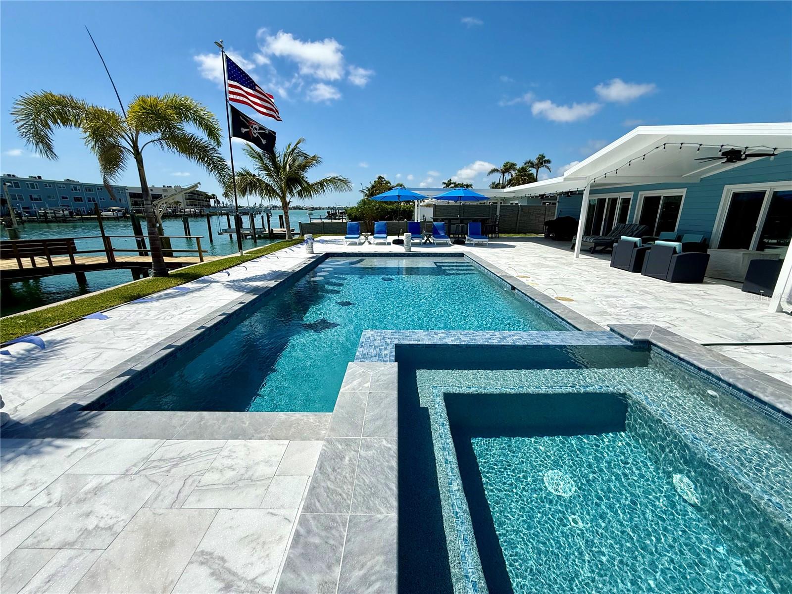 Waterfront, luxury, resort style living, solid 3 bedroom 2 bath, single family block home, keep your boat at the Dock on your 12,000 lb Boat lift, deep water canal with 80 feet of frontage . Daily Sunset views, located only a short bike ride to the Powdered sands of the Gulf of Mexico. Embrace the full width Hurricane sliders looking out to your oversized covered patio leading to your heated pool and spa, complete with decorative colored lighting. Enjoy the restaurants and entertainment at John's Pass. Nothing left to do, just move right on in, enjoy Multiple AC zones, all new duct work and split systems . Featuring solid stone counters and stainless steel appliances, the chef's design kitchen and breakfast bar, are top of the line. Plenty of counter space will make cooking a joy. The home offers a formal living room, formal dining room and a large Family room, with custom ship latch ceilings. You will love the master en suite, with walk in closet The bedrooms feature easy slide barn doors. and generous closet .Interior laundry room, new 200 amp electric service, double pane, hurricane window and doors. Large garage and roof is under 7 years.