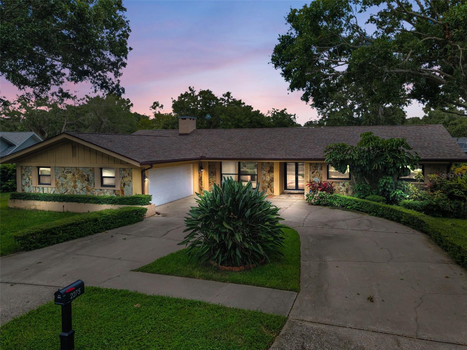 A rare opportunity at this centrally located Clearwater Gem! Located in the much desired Brookside Estates with beautiful majestic trees lined streets and within minutes to Florida’s top Gulf Coast beaches and all the amenities one can possibly desire. This home is exquisitely situated on a large premium home site with mature landscaping and loads of curb appeal with its circular driveway and side load garage. This charming pool home boasts over 2500 sq. ft. of comfortable and private living space and 4 bedrooms/3 baths with a Study/ office space that can be a possible 5th bedroom and a floor plan that features a possible flex space ideal for an in-law living quarters with its own bedroom/ full bath and sitting area with a double sided wood burning cozy fireplace. Tons of recent upgrades during ownership to include upgraded windows and sliding doors to top end CWS impact quality windows, a 3 yr new dimensional shingle roof with transferable warranty, updated dual zone AC system in 2022 and 2021, a 3 year new water heater, an upgraded kitchen and primary owner's bath to name a few! Enjoy gathering by the wood burning fireplace with family and friends at the sunken family room which flows seamlessly from the chefs dream kitchen and dining area with all its built-ins, center two level Island, upgraded SS appliances and open views of the pool and gorgeous outdoors. Lots of warm touches to enjoy to include warm stone trim and granite stunning floors. You will love the office space off the kitchen overlooking the sunken family room, the endless closet and storage space, the primary owner's suite with its open views of the sparkling pool and generous sized additional bedrooms. The screened-in fully and recently remodeled and resurfaced heated pool is simply the ultimate outdoor living space to enjoy the FL lifestyle with its private setting, endless lounging space of paver decking and the beautiful yard! Tired of HOA dues? Well no longer as this gorgeous neighborhood offers an optional HOA with 35.00 dollars annually. Awesome property and not to be missed!