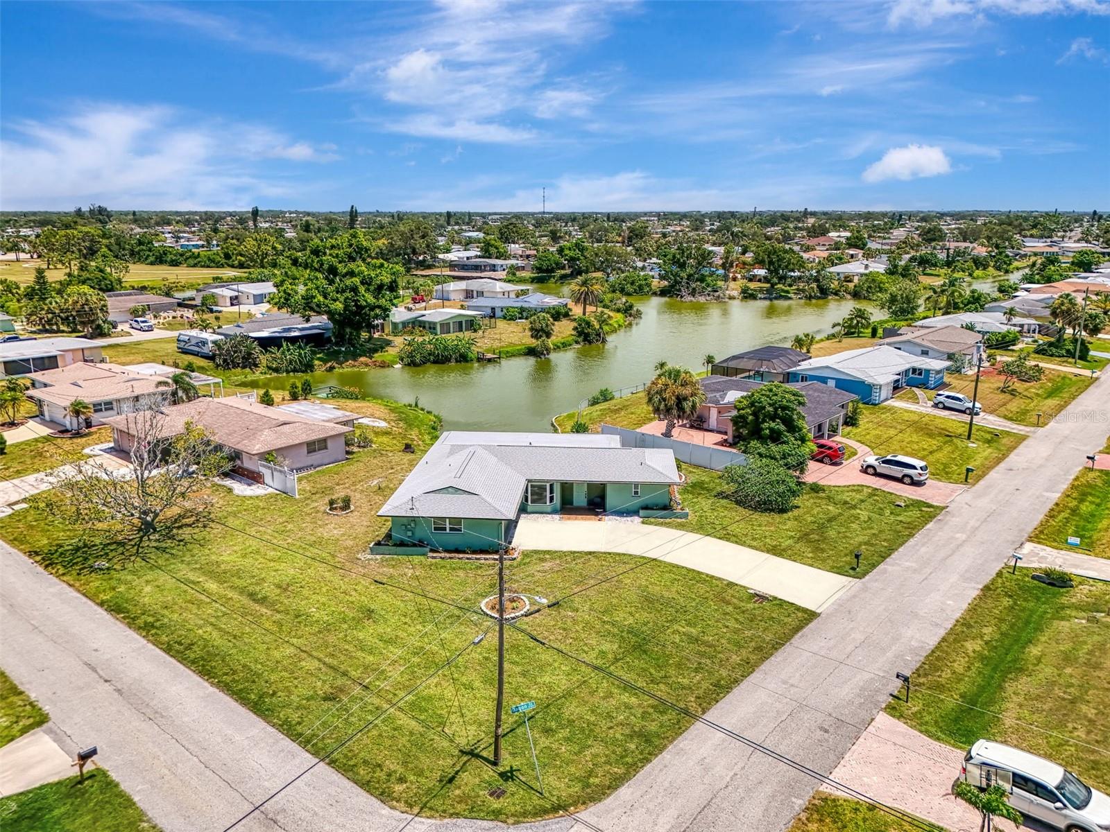 Now is your opportunity to own this Venice Gardens home, situated on an oversized corner lot with serene pond views. This home is located on CITY WATER AND SEWER and NO FLOOD INSURANCE IS REQUIRED! A NEW ROOF was just installed in 2023, and the home also features all hurricane impact windows that were installed in 2018. A brand new hot water heater was just installed in 2024. The upgraded Trane HVAC system has been regularly maintained. The home features charming curb appeal with a side load entry garage that houses a designated laundry area and a convenient utility sink. As you step through the front door you will appreciate updated tile floors that run throughout the entire home, making this home completely carpet free! The oversized living room is flooded with light thanks to the bay of windows in the adjoining dining room, as well as a wall of windows in the Florida Room that capture a view of the pond from every angle. The kitchen has a quaint breakfast nook, and the dishwasher and range were just replaced this year. The refrigerator has also recently been replaced. On one side of the home you will find an oversized Primary Suite with en suit bathroom with walk-in shower. There is also a large walk-in closet. On the opposite side of the house is a second bedroom that is generous in size and also features a walk-in closet. A second bathroom with shower tub combo is just off the second bedroom, and with a pocket door to section both the bedroom and bathroom off from the rest of the home, this easily acts as a second primary suite. In the back corner of the house you will find a large den/office with double pocket doors that can easily act as a 3rd bedroom if needed. Off the Florida room is a paver patio that is perfect for enjoying the Florida sun. This home has also been re-plumbed. This is a great opportunity to live within minutes of Venice Island, local beaches, and tons of area shops, restaurants, and attractions. Just around the corner you will find the Venice Gardens Civic Association where for a small fee, you can join to use the community pool and park. There is no mandatory HOA in Venice Gardens! If you have been dreaming of owning a piece of Florida’s paradise, then set up a private showing today!