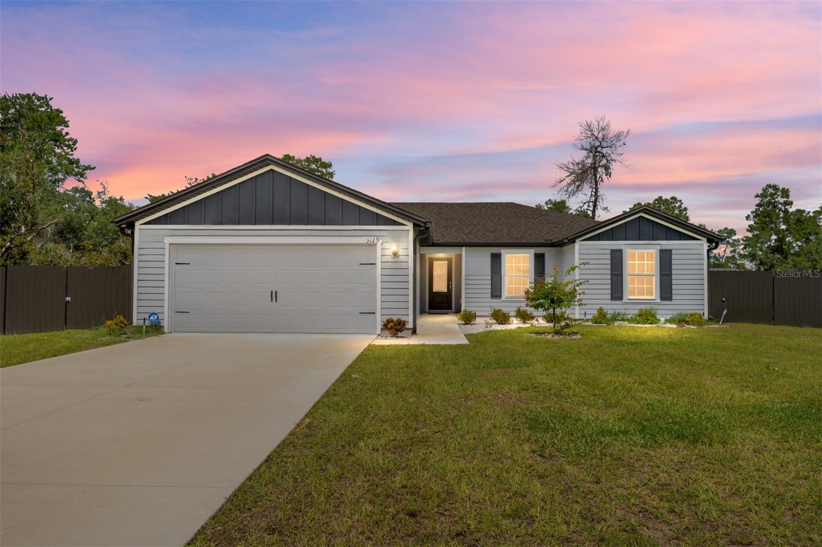 LIKE NEW, 2024 home with 3 bedrooms, 2 bathrooms, flex room and a 2 car garage. As you approach, you'll be greeted by a front patio and stone landscaping, providing great curb appeal. Step inside to discover a bright and inviting living room featuring vaulted ceilings, a ceiling fan, and a sliding glass door leading out to the screened lanai, offering a seamless indoor-outdoor living experience. The entire home boasts luxury vinyl plank flooring, with plush carpet in the bedrooms for added warmth and comfort. The kitchen features an island, granite countertops, under-cabinet lighting, stainless steel appliances, and upgraded light fixtures. The adjacent dining area is perfect for family meals or entertaining. The spacious primary bedroom offers a cozy retreat with vaulted ceilings, carpet, a fan, and blinds. The ensuite bath features a linen closet, a beautifully tiled shower with a glass door, a large single vanity with quartz countertops, and a generous walk-in closet. Bedrooms 2 and 3 are well-sized with carpet, fans, blinds, and closets. The second bathroom offers a quartz vanity and a tub/shower combo with tile accents. The versatile flex room can be used as a home office, playroom, or workout area, complete with a ceiling fan and blinds for added comfort. Enjoy the outdoors on the expansive 38x12 screened lanai, which is perfect for relaxing or entertaining, and features privacy screening and two ceiling fans. The fenced backyard is ideal for pets and privacy, featuring an aluminum fence with two gates. Additional features of this home include gutters and an ADT security system with cameras for peace of mind. Don't miss the opportunity to own this move-in-ready home in Marion Oaks! Schedule a showing today!
3D Tour and Floorplan available upon request.