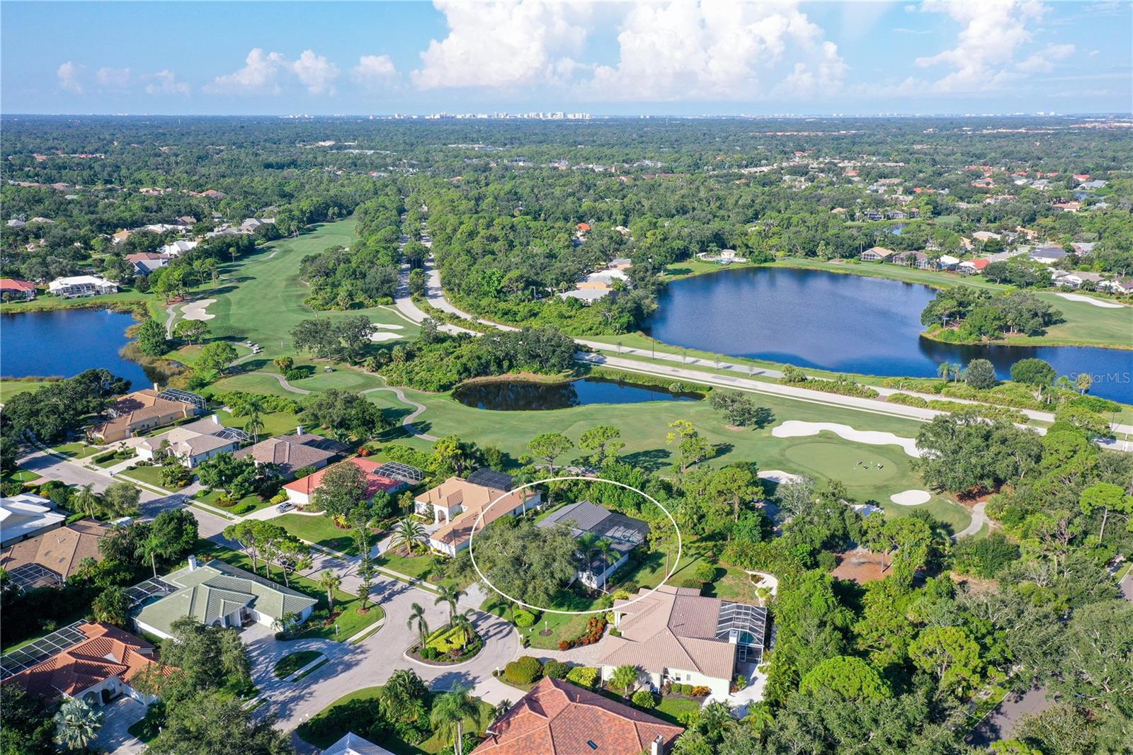 Welcome to a sophisticated blend of luxury and leisure in the exclusive enclave of Saint James Crossing, nestled within the gates of University Park Country Club. This meticulously updated four-bedroom pool home offers over 3,000 square feet of refined living space designed for effortless entertaining and serene daily living. From the moment you step through the double glass doors, you’re greeted by a sun-drenched open layout that flows seamlessly beneath soaring vaulted ceilings adorned with custom wood beams. This home has been beautifully reimagined in 2025 with brand-new pavered driveway and walkway, roof, windows, and sliding glass doors, as well as upgrades to the electrical and designer interior. Wide-plank hardwood flooring extends throughout the main living areas, grounding the modern design with warmth and character. At the heart of the home, a chef’s kitchen dazzles with crisp quartz countertops, custom cabinetry, designer lighting, and a spacious island with seating for four – perfect for family gatherings. The adjacent family room exudes a relaxed sophistication with a feature wall showcasing a linear fireplace and built-ins, while full walls of glass overlook the screened lanai and sparkling pool beyond. Retreat to the tranquil primary suite, where private patio access, a sitting area, and large walk-in closets elevate comfort. The spa-like bath invites indulgence with a freestanding soaking tub, dual vanities, and an oversized rainfall shower wrapped in luxurious tilework. Two additional guest bedrooms—each with high ceilings and ample natural light—provide versatility for family, guests, and a dedicated home office (fourth bedroom). Step outside to enjoy year-round Florida living in your own tropical sanctuary. The expansive screened lanai with paver decking, covered lounge space, and a pristine pool bordered by lush landscaping offers the ideal backdrop for quiet mornings or sunset swims. Set within one of Sarasota’s most prestigious master-planned communities, Saint James Crossing provides residents with access to an award-winning lifestyle. Enjoy 27 holes of championship golf, 11 Har-Tru tennis courts, four pickleball courts, a croquet lawn, fitness center, and a vibrant social calendar—all secured by a staffed gatehouse and framed by shaded, walkable streets. New homeowners are required to purchase a membership, ensuring a thriving, well-maintained community for years to come. Beyond the gates, you’re minutes from the upscale shops and dining of University Town Center, cultural experiences in downtown Sarasota, and the soft sands of Siesta Key and Lido Beach. Whether you're looking for a full-time residence or a winter retreat, this turnkey home offers the perfect harmony of style, comfort, and community.