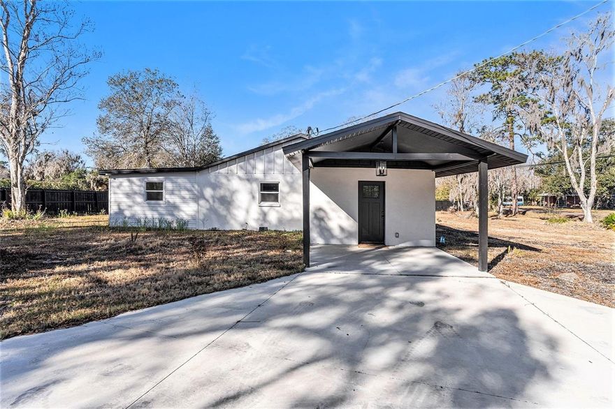 One or more photo(s) has been virtually staged. Completely renovated and truly move-in ready, this exceptional Odessa home sits on nearly three-quarters of an acre with no HOA. The expansive lot offers endless possibilities, including room for RV or boat parking, outdoor entertaining, or future expansion. Inside, the home features luxury vinyl flooring throughout and a bright, open layout anchored by a spectacular kitchen with white quartz countertops, stainless steel appliances, and an oversized island with built-in storage—perfect for both everyday living and entertaining. The living area is highlighted by a modern electric fireplace, creating a warm and inviting focal point. Major updates include a brand-new roof, AC system, and water heater, offering peace of mind for years to come. The attached 3-car garage is ideal for multiple vehicles, a workshop, or creative use such as a studio or hobby space. Conveniently located just minutes from the Veterans Expressway and Suncoast Parkway, with easy access to Tampa International Airport, downtown Tampa, shopping, dining, parks, trails, and award-winning Gulf beaches. This is a rare opportunity to own a fully updated home with space, freedom, and location—schedule your private showing today.