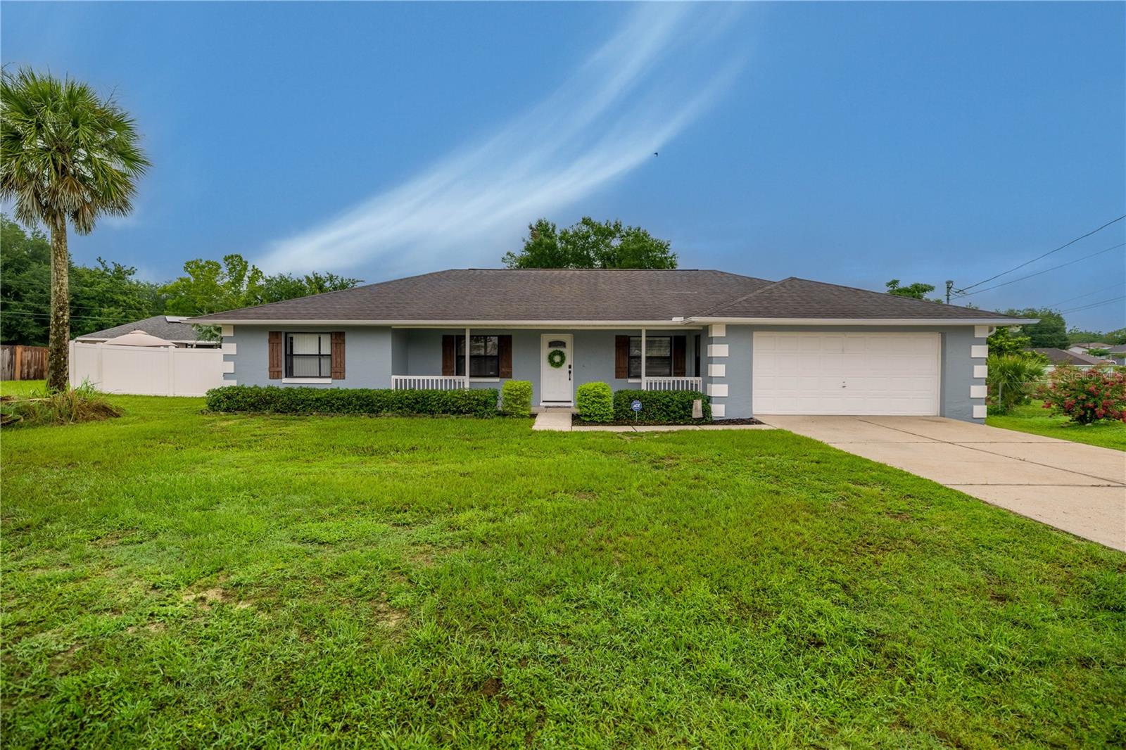 Welcome Home to this charming property in South East Ocala! Over 1/3 acre located in a quiet cul-de-sac with NO HOA. Watch sunsets from the front porch at the end of the day. This home features 4 bedrooms, 2 updated baths plus a bonus den or office space with a barn door for privacy. Enter the foyer and will notice the high ceilings, beautifully updated kitchen open to dining room and living area with wood burning fireplace and luxury vinyl plank flooring. The open floor plan has 2,163 living sq ft with split bedroom plan for privacy. Any chef will love cooking in this kitchen in the heart of the home. Light and bright with granite counters and bar top, beautiful cabinetry, stainless steel appliances and updated shelving in pantry. Interior laundry room with charming tile and washer and dryer convey. The Primary suite is generously sized with an enviable walk in closet and shelving. The spa like bath has double vanity glass sinks and walk in tiled shower. The backyard is enclosed with a white vinyl privacy fence with gates on both sides, move-in ready for your furry friends. There is also an open patio area for grilling or entertaining. Recent updates include: Roof 2016, Fence 2020, Septic pumped 2021, Exterior Paint and Cedar Shutters 2023, Whole House Plumbing Re Pipe through Attic 2023, Duct Cleaning 2023, Interior painted and new baseboards 2024, as well as Solar panels installed in 2018 (Paid off at Closing) - Owner enjoyed low monthly electric bills averaging $40 month. Zoned for Greenway Elementary, Fort King Middle and Forest High School. Great South East location and close to all amenities. Expect to be impressed by the charming feel and decor of this unique floorplan and property. Hurry and schedule a showing and see for yourself everything this home has to offer.