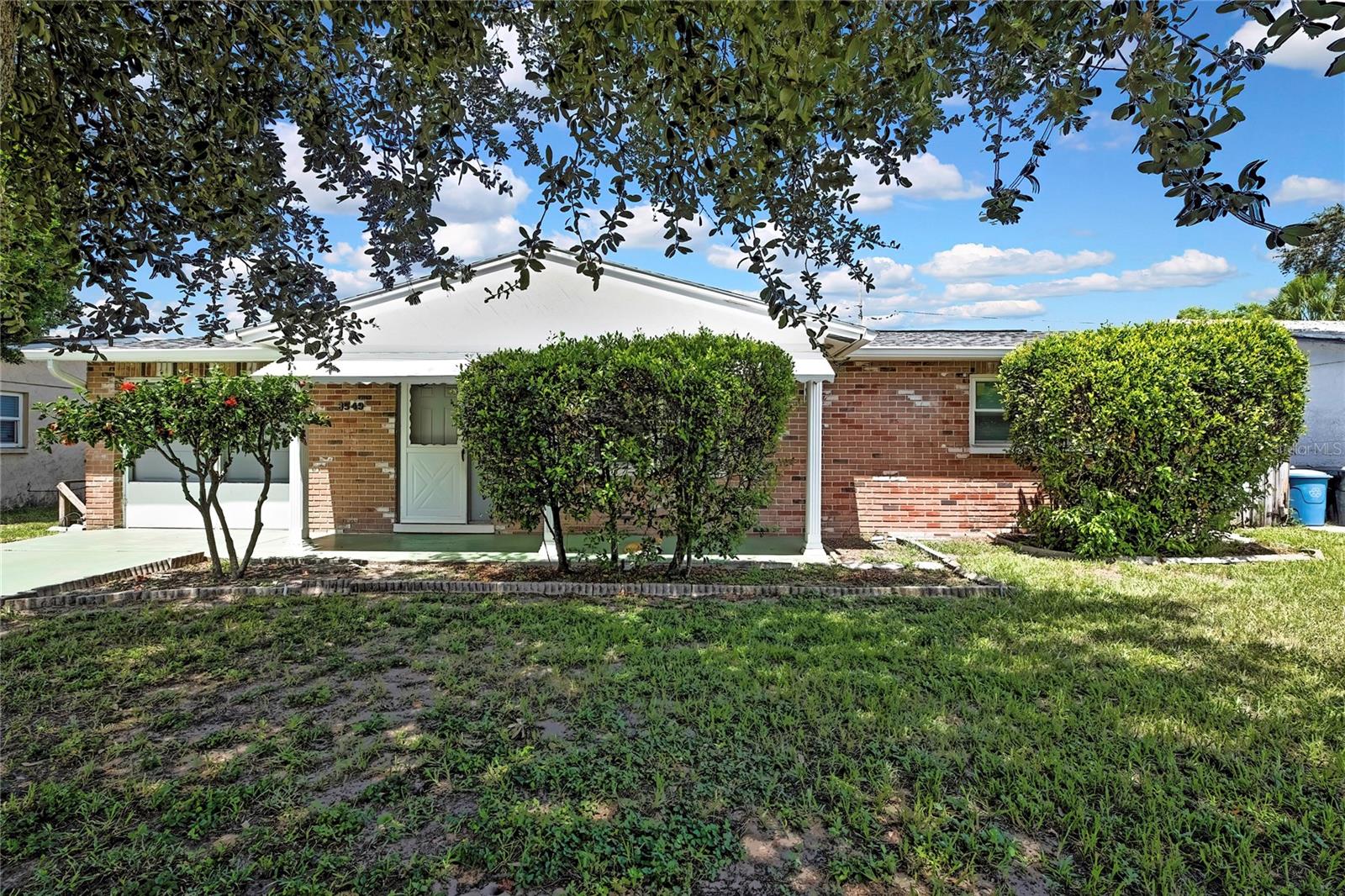 Welcome to this charming home located in a peaceful New Port Richey community. This 2-bedroom, 1 and 1/2-bath block construction residence offers a comfortable 1,004 square feet of living space on a generously sized lot. Step inside to find fresh interior paint and easy-to-maintain terrazzo floors, that have been recently covered by the laminate in both living area's; complemented by a tiled kitchen featuring a brand-new refrigerator and ample cabinetry. The Florida living room invites natural light while the other living/reading room overlooks the spacious backyard—perfect for outdoor entertaining with family and friends. Recent major updates add to the home's value and peace of mind, including a new roof (2021), air conditioning system (2021), water heater (2021), and a new electrical panel. The attached one-car garage and covered front porch provide added convenience and curb appeal. Located just minutes from shopping, dining, and local parks, this home combines modern upgrades with classic Florida charm—ideal for first-time buyers, seasonal residents, or savvy investors. Come take a tour and make this house your home today!