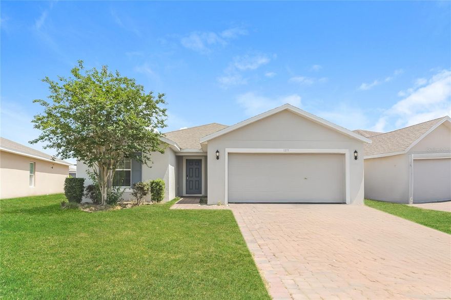 Situated in the heart of Central Florida's growing Polk County corridor, 1373 Lucerne Loop Road NE offers the kind of newer construction that is increasingly difficult to find at this price point. Winter Haven's continued growth, strong school access, and easy reach of both Tampa and Orlando make Lucerne Park a smart place to put down roots.
The single-story layout was built in 2019 and designed with family living in mind. At 1,746 heated square feet, the home offers four bedrooms, two full baths, and an open kitchen and family room combination that keeps everyone connected. The kitchen features solid surface countertops, solid wood cabinets, a kitchen island, pantry, and a full appliance package. Tile flooring runs through the main living areas, with vinyl in all four bedrooms. The primary suite includes a walk-in closet and en-suite bath with dual sinks and a shower. Three additional bedrooms each offer built-in closet storage and flexibility for family, guests, or a dedicated home office.
An interior laundry room, window treatments throughout, central air, and a two-car attached garage with opener provide the day-to-day practicality families rely on. The covered front and rear porches offer room to unwind, and the landscaped 0.15-acre homesite sits on a paved, sidewalk-lined street within a deed-restricted community where golf carts are welcome. Zoned for Lake Alfred Elementary, Boone Middle, and Haines City Senior High. HOA fees of $30 per month. Flood Zone X.