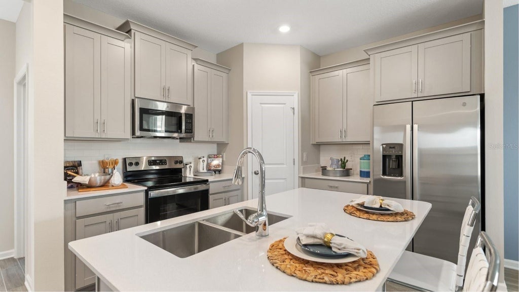 Photo of 5630 Kettlebell Alley, Clermont, FL 34714 (MLS # O6440676)