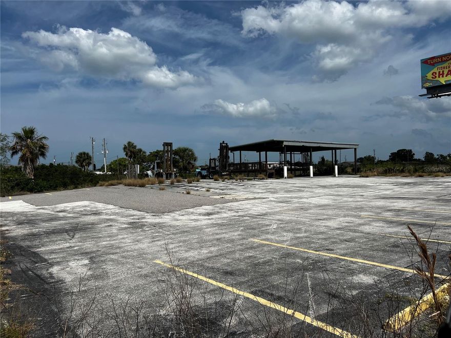 1.38 acres on US 19 and Puffin Lane in Hudson Florida, chain link fenced with a 2244' covered area with concrete floor, paved parking lot. Zoned C2.