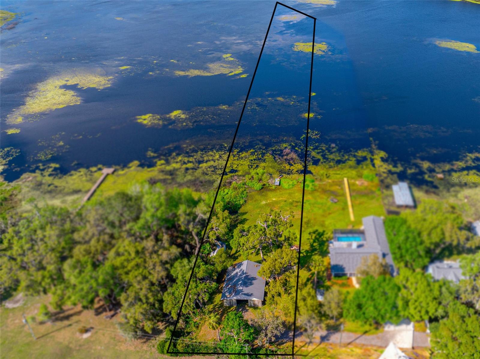 An amazing and rare opportunity to build your dream home on Hancock Lake's breathtaking,
private shore! With 111 feet of direct frontage, this peaceful lakeside retreat is zoned Estate
Residential and offers endless possibilities for the new owner. Whether you envision building
your lakefront oasis or embracing a country-living lifestyle, this property will deliver. Bring your
personal agricultural animals and take advantage of the existing 1,512 sq. ft. open barn, plus a
separate storage building for added convenience. A true slice of Florida paradise awaits! Are
you looking for a home that is already completed? The stunning 3 bedroom, 3 bath pool home
next door is available for sale separately! Call us today to learn more about this gorgeous 2.62
acres in a picturesque Dade City location!