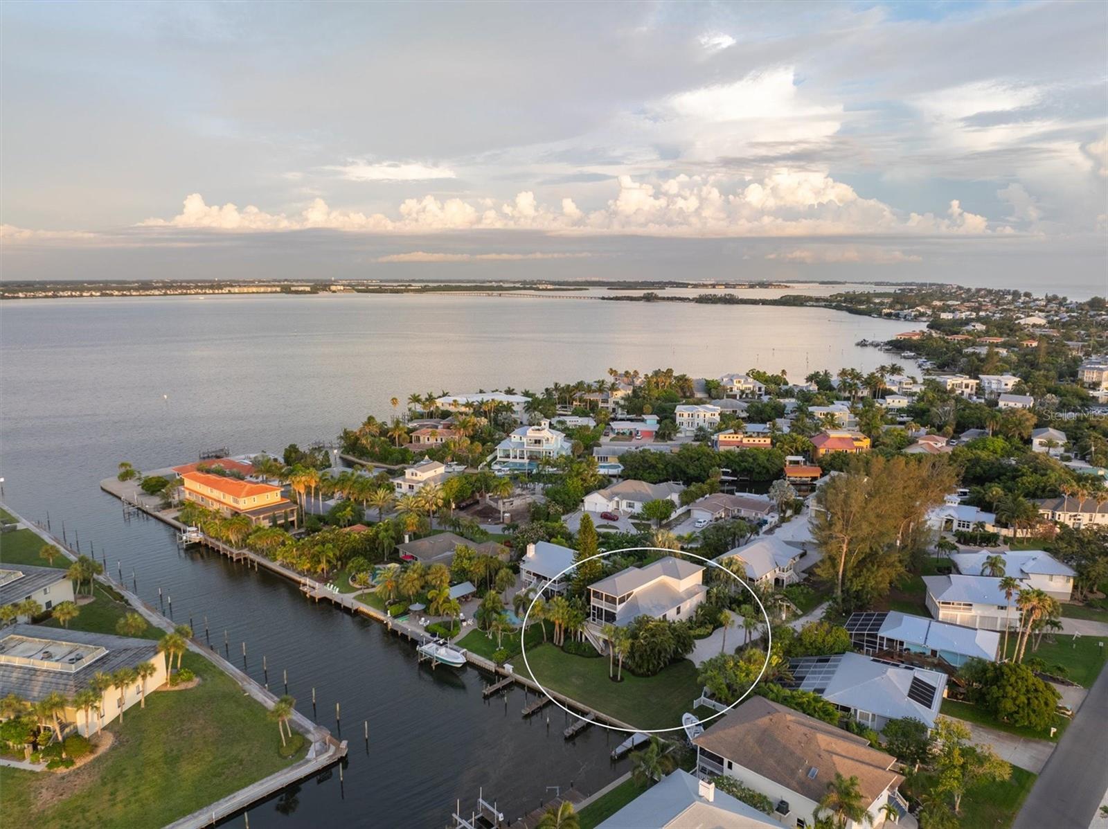 This home has been thoughtfully remediated and restored post storm. Experience gracious island living in this custom-built ELEVATED home, nestled along the canal in a quiet, no-HOA neighborhood near the heart of downtown Holmes Beach. Built in 2006, this thoughtfully designed residence offers both privacy and convenience in a serene coastal setting. You’ll enjoy easy access to deep water, great restaurants, unique shops, beautiful beaches, and recreational parks. This expansive home has an airy, welcoming layout with ample space for entertaining or relaxing. The multi-level floor plan includes three spacious bedrooms with multiple levels of balconies and porches, offering breathtaking views of the canal and open water. The main level owner's suite with luxurious spa bathroom ensures privacy and convenience. This residence features a four-car garage, providing plenty of space for your vehicles, toys, and hobbies. An elevator ensures easy access to all levels. Additionally, there’s room for a pool, making it an ideal spot for outdoor entertaining. With your private dock, you can be out on the open water in minutes, with no bridge restrictions for boat height. As one of the few elevated homes in the area, this property’s structural integrity offers peace of mind, allowing you to enjoy everything on Anna Maria Island. Don’t miss the opportunity to make this stunning home your own!