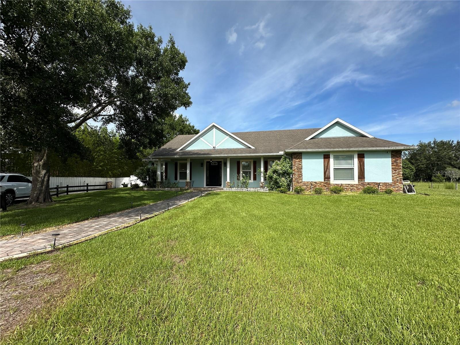 Enjoy peaceful country living just minutes from Lake Nona and city conveniences in this beautifully maintained 2-bedroom, 1.5-bath home nestled on a private 2-acre lot in a quiet, sought-after neighborhood of St. Cloud.
This home offers approximately 2,400 square feet of thoughtfully designed living space. The bright and airy living room features soaring ceilings, modern light accents, and a cozy fireplace, creating a warm and inviting atmosphere. The open-concept kitchen flows seamlessly into the main living area, making it ideal for both everyday living and entertaining. The primary suite includes a full bathroom, while the guest bedroom is served by a convenient half bath. Ceramic tile flooring runs throughout the home, and ample closet and storage space add to the home's functionality.
Step outside to enjoy a beautifully landscaped backyard complete with a screened-in patio that looks out onto lush green space, mature trees, and blooming flowers. The outdoor amenities are a rare find, including a small pool, a jacuzzi, an additional storage shed, and even a farmhouse perfect for raising chickens or ducks—offering a truly unique lifestyle opportunity.
Please note, while the home is technically a 3-bedroom, 2.5-bath property, the owner will retain one bedroom and one bathroom on the right side of the house for personal storage use. This portion of the home has a completely separate entrance and will not interfere with the tenant's use of the main living space.
Tenants are responsible for electricity, internet and cable, lawn care, pest control, and pool maintenance if they choose to use the pool. Water and sewer are included in the rent. Lawn care is not included, but the owner can offer monthly lawn maintenance through their vendor for an additional $400 per month if desired.
Located just minutes from Lake Nona, shopping, dining, and top medical facilities, with easy access to the Florida Turnpike, this home offers the perfect blend of privacy, convenience, and lifestyle. Whether you're looking for space to relax, entertain, or even start a small hobby farm, this St. Cloud gem delivers it all.