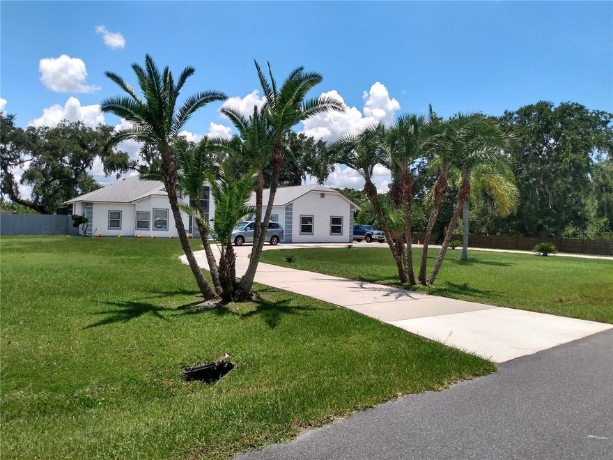 Discover this rare find in an established neighborhood with NO HOA and close to all of Central Florida's attractions. This property if over an acre with a large circular drive and abundant parking for friends and family. It even has an RV space with hookup for electric, water and sewer. It has mature landscaping with beautiful Oak trees and a fully fenced back yard for your furry friends. There are 2 outbuildings for storage of pool and landscape tools. Exit the house through french doors to the exceptional entertainment area featuring a hot tub that water falls into the kidney shaped pool with custom pavers and large patio area all covered by an upgraded screened enclosure. The back of the property is lined with exotic bamboo trees for privacy and provide a tranquil setting. Inside the home is an efficient kitchen with granite countertops and stainless appliances including a double oven. The large primary suite is secluded on one side of the home and has a walk-in closet with 3 tiers of hanging storage. The bath features a double vanity and large shower with double shower heads. There is also a garden tub if you prefer to soak. The other side of the house has 2 more bedrooms with another full bath and separate entrance. There is a living room, dining room and family room with a wood burning fireplace with high ceilings in between. The fireplace has a gorgeous wood mantel and a raised hearth. The entire house has been replumbed to meet current codes and a new energy efficient water heater was installed. The 3 car finished garage with workshop has 8ft doors and is heated and cooled. There is a 10x23ft bonus room that you can use to suit your needs. For the exercise lover you have access to miles of sidewalks and bike lanes. All this and other hidden gems for you to discover.