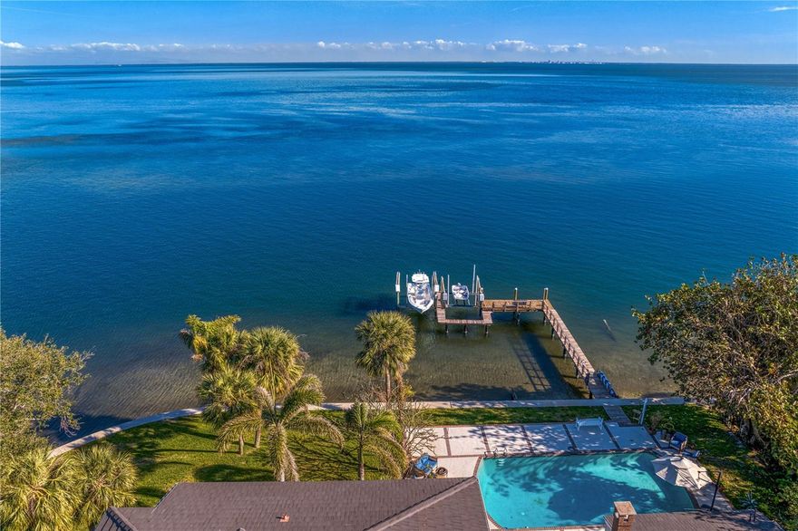 Breathtaking open water views! This stunning 6 bedroom 5.5 bath home never flooded and experienced no water intrusion. Sitting high the home includes an office, library, mother-in-law suite, bedrooms with en suites, his and her master baths, THREE fireplaces, open great room with wet bar and more. Situated on more than 125ft of deep, open water the views and the lot itself will leave you speechless. Enjoy the expansive dock with two boat lifts that easily accommodate your toys. Close proximity to the beaches, Downtown St. Petersburg and Tampa International airport yet you come home to feel like you are in your own world. Welcome home!!!