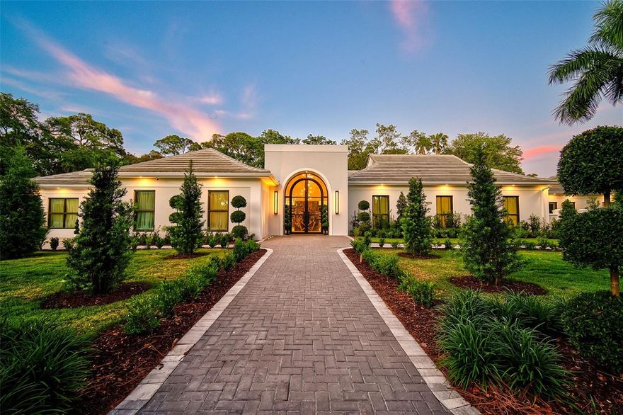 **EXQUISITELY DESIGNED ESTATE BOASTS MODERN & CONTEMPORARY ELEGANCE** This FULLY UPDATED Residence features a MAIN HOUSE with 3Beds/4.5Baths plus GUEST HOUSE (1Bed/1Bath, Kitchen/Laundry, Living area) and is situated on an Oversized, Private and Serene DOUBLE LOT in the SECURE, OAKS BAYSIDE Country Club Neighborhood on Little Sarasota Bay.  Finishes of the highest quality abound and include Custom Iron entry and interior doors, Italian Murano sconces and chandeliers, architectural recessed lighting, Marble and Porcelain Flooring, Iron and Glass custom Wine Cellar, Glass enclosed “Spirits” Showcase, luxury appointments and fixtures throughout and is a MUST SEE!  The GOURMET KITCHEN is impressively equipped with top brands including SUBZERO, WOLF, 2 ASKO dishwashers, “Waterstone” gantry faucets, work-station sinks, custom range hood, MIELE Coffee Station, etc. In total, there are 2 kitchens and 3 laundry facilities.  The Stunning OUTDOOR ENTERTAINING area features a spacious screened lanai with Gorgeous, Saltwater, Heated, Pebbletec 64ft Lap Pool and Spa, Marble deck, OUTDOOR KITCHEN with Twin Eagles Grill, 2 refrigerators, covered gathering area with fireplace, air-conditioned Pool Bath with Aromatherapy Steam Shower (New in 2024), storage room and Additional Open Air Patio with FIRE PIT.  Extensive Home Automation (Control4: sound, lighting, etc.) and Mechanical system installations were thoughtfully executed and include a Generator, water treatment and purification systems, robust Wi-Fi throughout, Vivent video monitored security system, Air-Conditioned Garage with EV charging, resin coated floors and utility sink, etc.  Impressive grounds with new landscaping, hardscaping & lighting.  Newer ROOF, HVAC, Hurricane Impact Rated Windows and Doors.  THE OAKS-BAYSIDE is a distinguished, 24hr Guarded, Country Club Community which boasts many accolades including: Platinum Club of America, Emerald Club of the World and Elite Distinguished Club of the World - where amenities include two, 18-hole championship GOLF courses, award-winning TENNIS program with 12 Har-Tru Hydro-Grid TENNIS courts, 4 PICKLEBALL Courts, wonderful CROQUET facility, state-of-the-art FITNESS center and junior Olympic, heated community SWIMMING POOL. The Oaks is just minutes from nationally ranked Pine View School, the Legacy Bike Trail, area Beaches and all that Gulf Coast living has to offer. Membership is required and there is NO WAITLIST for GOLF or SOCIAL Membership. **ENJOY THE 3D VIRTUAL TOUR and AERIAL VIDEO**