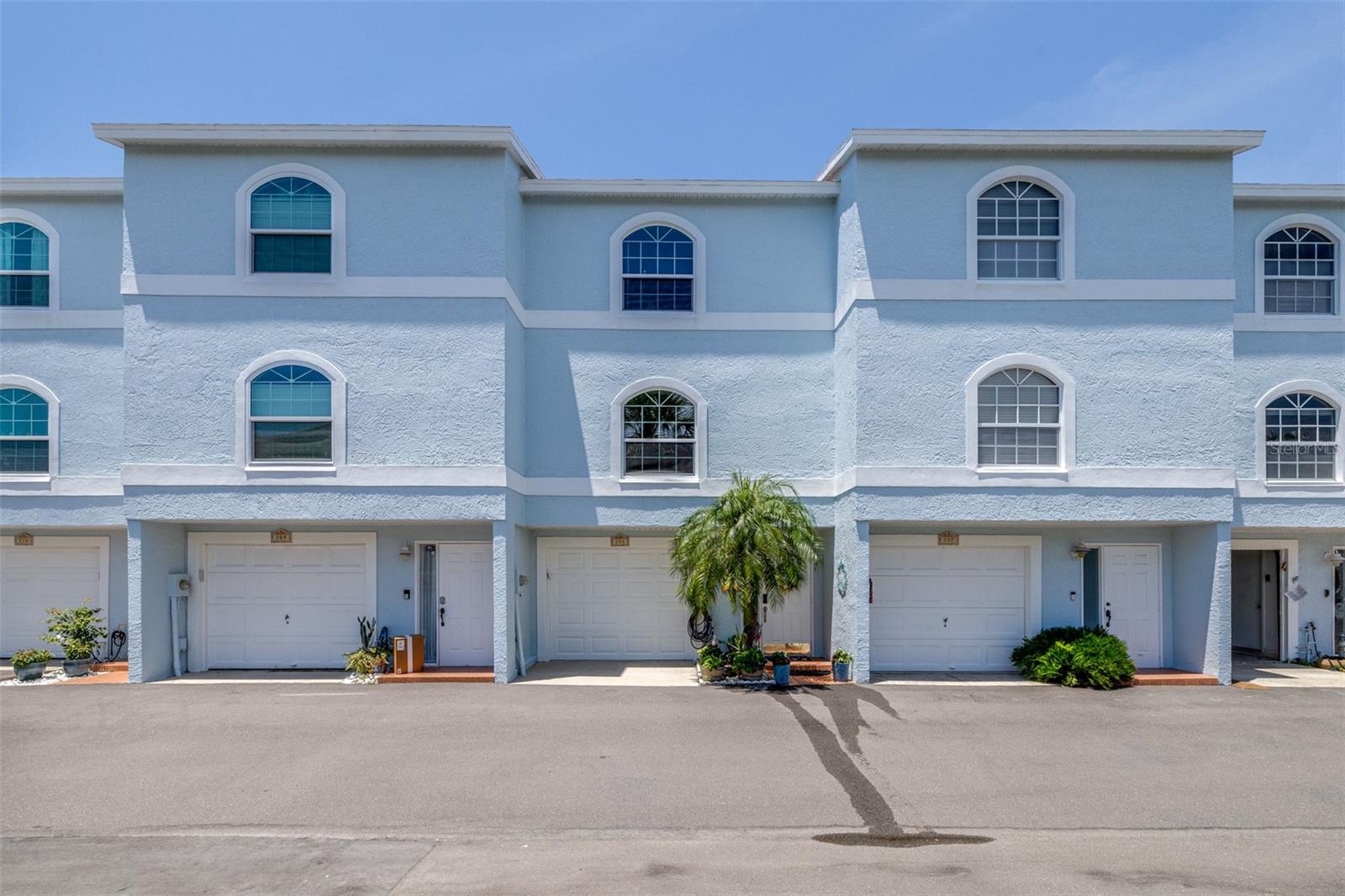 Welcome to 751 Pinellas Bayway S #208. A radiant townhome nestled in the heart of Tierra Verde, where costal charm meets elegant comfort. This three-story Florida-style residence offers 2 spacious bathrooms and 2.5 baths across 1,600 square feet of thoughtfully designed living space. The main level greets you with an open-concept layout, featuring a recently updated kitchen adorned with white cabinetry and stainless-steel appliances. From the kitchen, your gaze flows effortlessly to the wood-burning fireplace, dining area, and living room, which opens onto the first of two extra-wide screened balconies overlooking the shimmering pool. The primary suite is a sanctuary of its own, complete with tall ceilings, dual closets, and a tiles sitting area with sliding glass doors. The en-suite bath boasts a generous walk-in shower, a garden tub, and dual sinks - perfect for unwinding after a day on the water. Below, a tandem garage offers ample space for vehicles, storage, or even a workshop. Upstairs, the laundry room is conveniently located near both bedrooms, adding a layer of everyday ease. Just steps from the Intercoastal Waterway, this home is a boater's dream. Enjoy fishing from the dock, lounging by the pool, or exploring nearby Fort DeSoto Park with its nature trails, kayaking spots, and dog-friendly beach. With easy access to I-275 and downtown St. Petersburg, you're never far from vibrant dining, arts, and entertainment. This townhome isn't just a place to live - it's a lifestyle. *Recent Upgrades* Tankless Hot Water Heater (2024), Hurricane Sliding Door on Main Floor (2025), Hurricane Windows on Main Floor (2025), New Sliding Door in Primary Bedroom (2025), Remodel Master Bathroom (2025), Re-Created Laundry Area (2025), Added a half bath and sink downstairs in "Bonus Room" (2025)