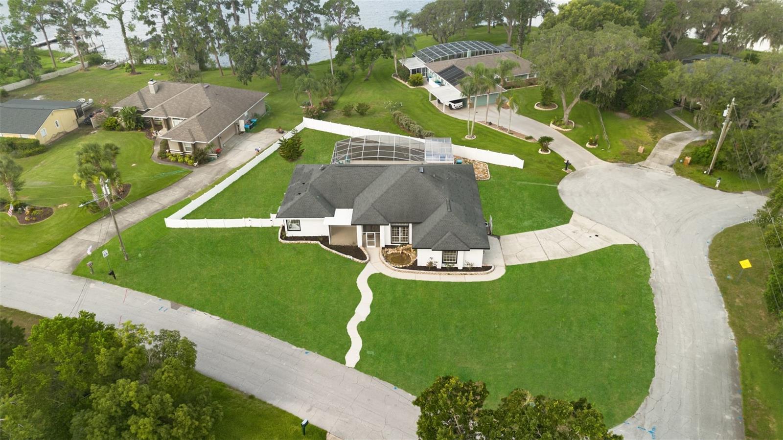 Welcome to 1148 Rosetta Drive E – Your Private Lakefront Oasis
This is the dream home you’ve been waiting for! Perfectly positioned with serene views of Lake McGarity, this fully renovated residence offers the perfect balance of luxury, comfort, and modern design—whether you’re entertaining guests or enjoying peaceful everyday living.
Step through the custom glass-etched front door and into a bright, open-concept layout that seamlessly connects the foyer, great room, formal dining space, and an absolutely stunning chef’s kitchen. Designed to impress, the kitchen features quartz countertops, stainless steel appliances, modern cabinetry, designer backsplash, a walk-in pantry, and abundant storage.
The primary suite is a private retreat with direct access to the pool, a spacious walk-in closet, and a spa-inspired bathroom boasting a soaking tub, walk-in shower, and dual vanities—all finished with elegant, high-end details. Two additional bedrooms are generously sized, offering flexibility for family, guests, or a home office.
Four sliding glass doors lead to the expansive outdoor living area, where indoor and outdoor spaces flow together effortlessly. Relax year-round in the screened-in lagoon-style pool, complete with a large covered lanai—perfect for gatherings or quiet evenings by the water.
With a newer roof, HVAC system, and water heater, this home offers both peace of mind and energy efficiency.
Homes of this caliber in this location are rare—don’t miss the opportunity to make 1148 Rosetta Drive E your very own lakefront paradise!