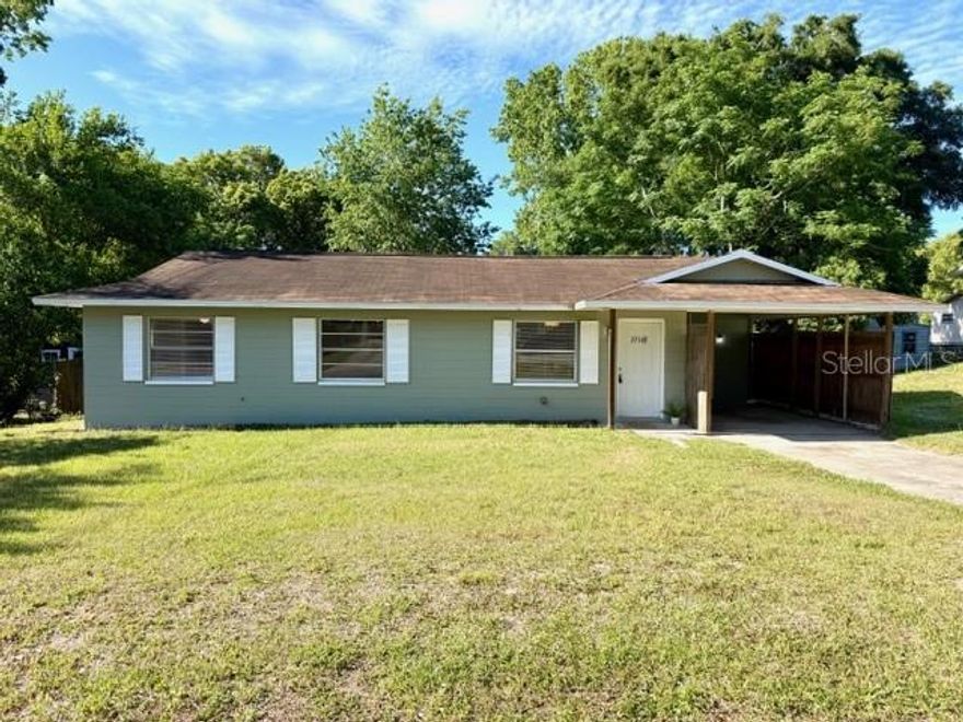 Charming and affordable, this 3-bedroom, 1.5-bath offers a fantastic opportunity for a first-time homebuyer, investor, or anyone looking for a move-in ready property. Situated on nearly a quarter-acre lot with no HOA and not in a flood zone, this home combines value, convenience, and flexibility.  Step inside to an inviting open floor plan with comfortable living spaces and new carpet adding a fresh touch. The freshly painted exterior enhances curb appeal.  Outside, enjoy a fenced backyard with plenty of room for pets, play, gardening, or future outdoor additions. The covered carport includes a designated laundry/utility room, providing extra storage and convenience.  Built with durable block construction and ideally located with quick access to the highway, commuting to Ocala, Tampa, and surrounding areas is a breeze. Close to shopping, dining, and everyday amenities, this home offers both peaceful living and accessibility. Roof 2016, HVAC 2010