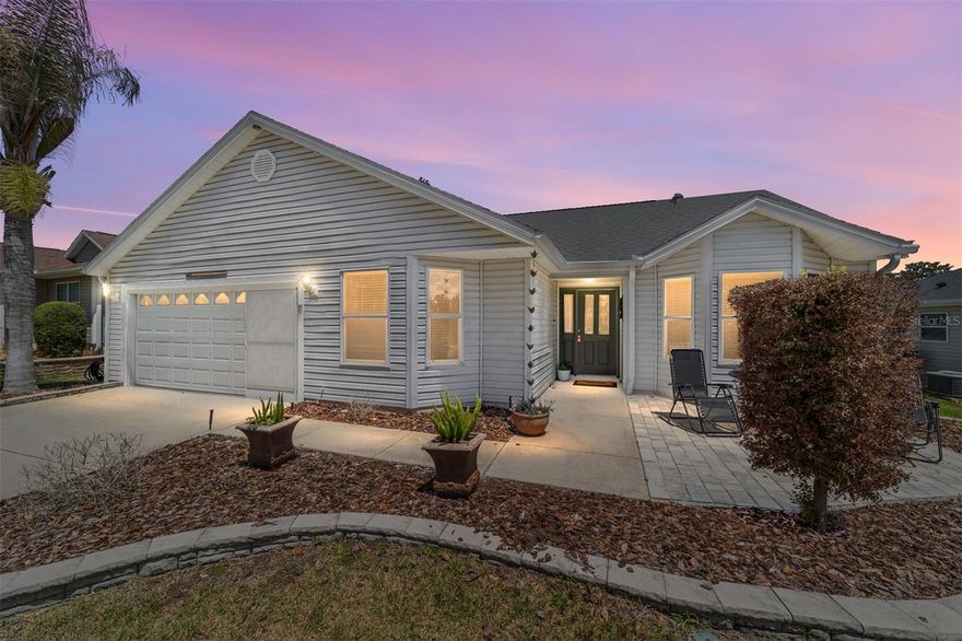 Welcome to this Willow/Wisteria DESIGNER home in the VILLAGE OF PIEDMONT! This beautifully appointed 3 bedroom, 2 bathroom home is the perfect size for full time or seasonal living, offering a TRUE SPLIT FLOORPLAN that gives family and guests their own privacy.
Step inside to find HARDWOOD FLOORING in the living and dining room, VINYL FLOORING in the kitchen and guest bedroom, and CARPET in the master and second guest bedroom. VAULTED CEILINGS, CROWN MOLDING, CHAIR RAIL, and FRENCH DOORS to the lanai define the main living space and create a warm, inviting atmosphere throughout.
The kitchen offers easy access to the garage and features WHITE CABINETRY, PULL OUT DRAWERS in the cabinets and pantry, a TILE BACKSPLASH, STAINLESS STEEL APPLIANCES, UPDATED LIGHTING, CHAIR RAIL, and an EAT-IN SPACE perfect for casual dining.
The primary suite features CARPET and a WALK-IN CLOSET, and leads into the EN SUITE PRIMARY BATHROOM appointed with GRANITE COUNTERTOPS, WHITE CABINETRY, an UPGRADED FRAMED MIRROR, a TILED WALK-IN SHOWER, and convenient access to the LAUNDRY ROOM. Both guest bedrooms offer BUILT-IN CLOSETS, with one highlighted by beautiful BAY WINDOWS. The guest bathroom is well appointed with a TUB/SHOWER COMBO WITH GLASS DOOR and WHITE CABINETRY.
The ENCLOSED LANAI features ACRYLIC WINDOWS, CHATTAHOOCHEE RIVER ROCK FLOORING, and a SEPARATE AIR AND HEAT UNIT for year round comfort. Just off the lanai, enjoy a large PAVER PATIO surrounded by MATURE LANDSCAPING with CURBED RAISED MULCH BEDS, perfect for soaking up the Florida lifestyle.
Additional highlights include: NO BOND, HWH 2023, ROOF 2023, NOVA WATER FILTER 2023, HOME WARRANTY UNTIL 2029, MOTORIZED AWNING, SOLAR TUBES, MANUAL GARAGE SCREEN, ATTIC STAIRS, ENHANCED LIGHTING FIXTURES, and a PAINTED GARAGE FLOOR! You are just minutes from SPANISH SPRINGS and LAKE SUMTER LANDING TOWN SQUARES for free nightly entertainment, restaurants, and all the best The Villages has to offer!