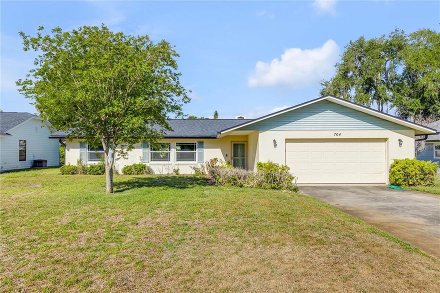 Centrally located New Smyrna Beach 3 Bd, 2Ba, 2 Car Garage home just minutes to shopping, dining, the municipal golf course and the beach! Roof replaced yr 2023. Open floor plan between living room, kitchen and dining room.  The kitchen features ample counter space, white cabinets and white appliances.  There are ceiling fans in all rooms with a stone fireplace in the living room.   Primary bedroom includes an en-suite bathroom, with walk-in shower.  Convenient access to US-1 and the Causeway makes commuting and beach a breeze in a few minutes. . Ideal for a primary residence, seasonal getaway, or investment opportunity. No HOA.