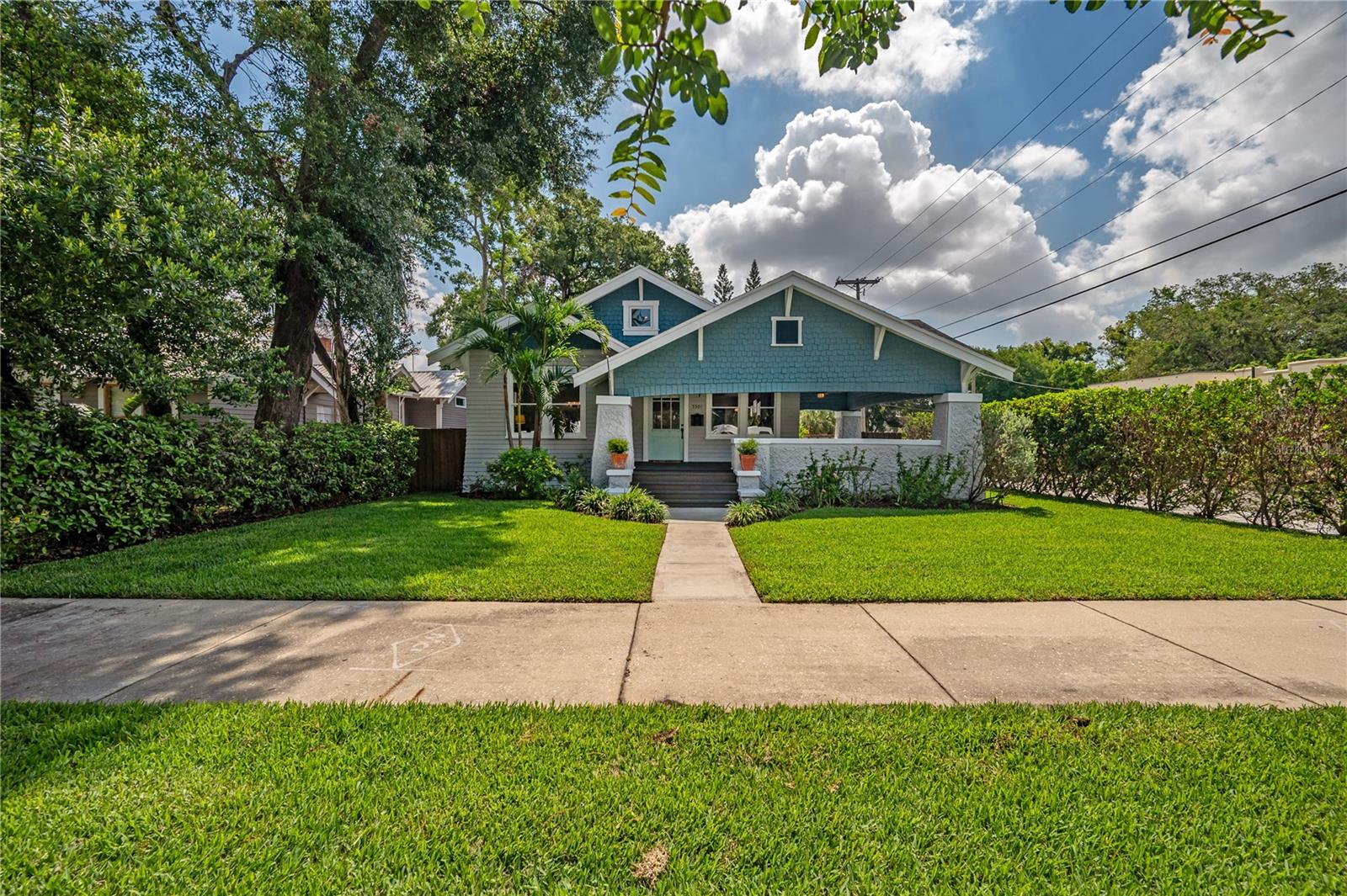 Step into timeless charm with this beautifully restored 1905 bungalow for rent in the heart of Seminole Heights, tucked away on one of the most picturesque streets in the Historic District — Central Avenue. This home captures the essence of historic craftsmanship while offering the modern updates and comfort today's renters are looking for.
From the moment you arrive, the oversized wraparound porch sets the tone — the perfect place to sip your morning coffee or wind down in the evening, surrounded by the quiet beauty of a tree-lined, walkable neighborhood. Inside, you’ll find original hardwood floors that glow with character, soaring tray ceilings, and a stunning brick wood-burning fireplace that anchors the living space. The open-concept layout makes everyday living and entertaining effortless, flowing seamlessly from the living room into the dining area and onward to the show-stopping kitchen.
The kitchen is an absolute dream, with striking Calacatta quartz countertops, custom shaker cabinetry, designer hardware, a mosaic tile backsplash, and high-end stainless steel appliances — even a built-in wine fridge. Tucked away on the first floor for privacy, the spacious primary suite is a calming retreat with room for a king-sized bed and a cozy reading nook, while the en suite bath feels like a spa with its thoughtful design and luxurious finishes. Two more bedrooms offer charm and flexibility, whether you're hosting guests, working from home, or just need a bit more space.
Upstairs, a loft area offers the perfect bonus space for whatever your lifestyle needs — a reading corner, creative studio, playroom, or workout zone. The home has been thoughtfully updated throughout, with major systems like plumbing, electrical, and HVAC already taken care of, as well as a new roof and beautiful landscaping that add to the curb appeal.
Located just a short stroll from neighborhood favorites like Spaddy’s Coffee, The Independent, and Health Mutt, and surrounded by parks, yoga studios, weekend markets, and some of Tampa’s best dining spots, this rental offers more than just a place to live — it’s a chance to experience the best of life in Seminole Heights.