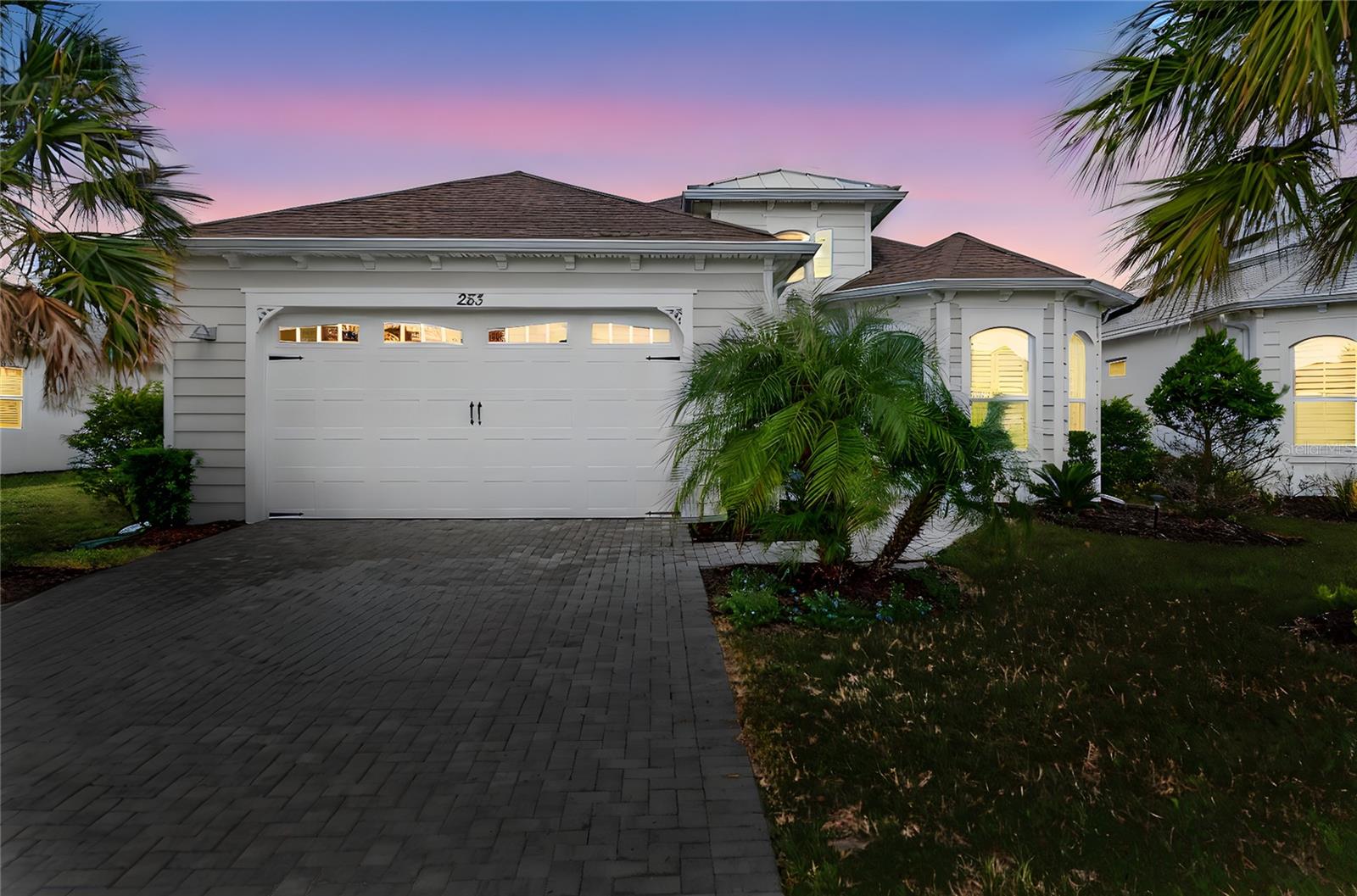 Welcome to paradise in Latitude Margaritaville! This upgraded Breeze model sits atop an oversized premium waterfront lot, offering refined comfort and relaxed living with over $35k in upgrades. The spacious kitchen is the heart of the home, featuring upgraded energy-saving stainless steel appliances, a gas range, under-cabinet lighting, and an enormous island accented with unique shiplap detailing — perfect for cooking and entertaining. Attention to detail abounds, including plantation shutters, recessed lighting and blown-in attic insulation for enhanced energy efficiency. There is also a paver driveway and an upgraded lanai with custom roll-down shades. Enjoy resort-style amenities, including a private beach club with transportation, sparkling pool and recreation, and an on-site restaurant.